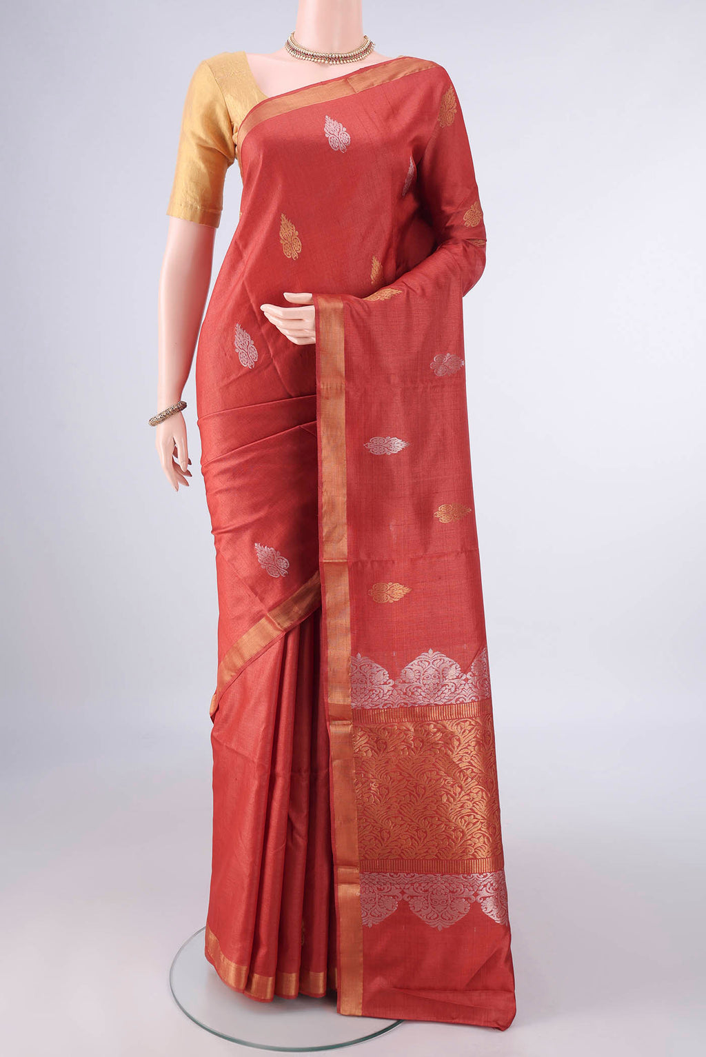 Rust MP Tussar Saree with Zari Butta on the body and Zari Border.  displayed on a mannequin