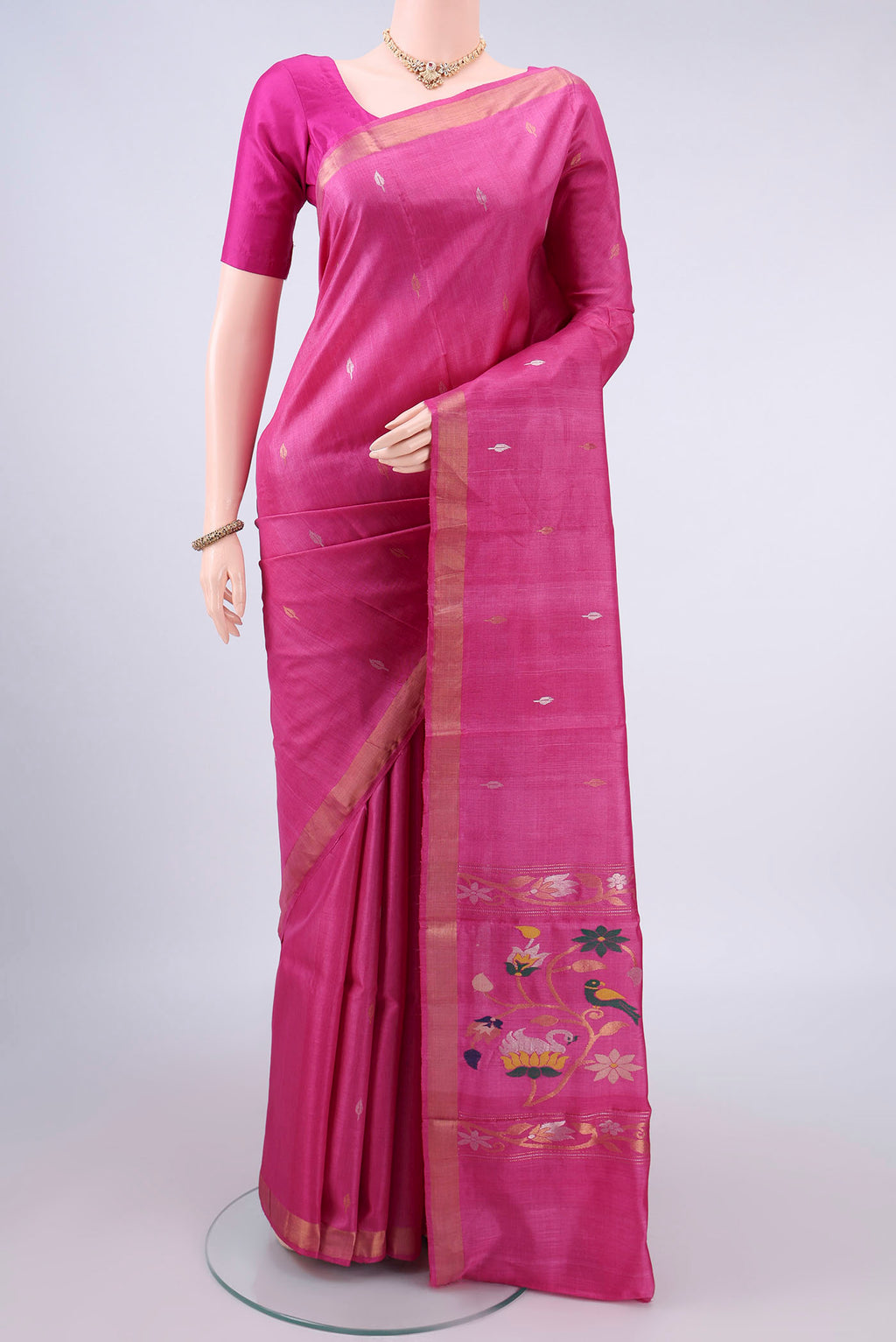 Rani Pink Tussar Saree with Zari Butta on the body and Zari Border.  displayed on a mannequin