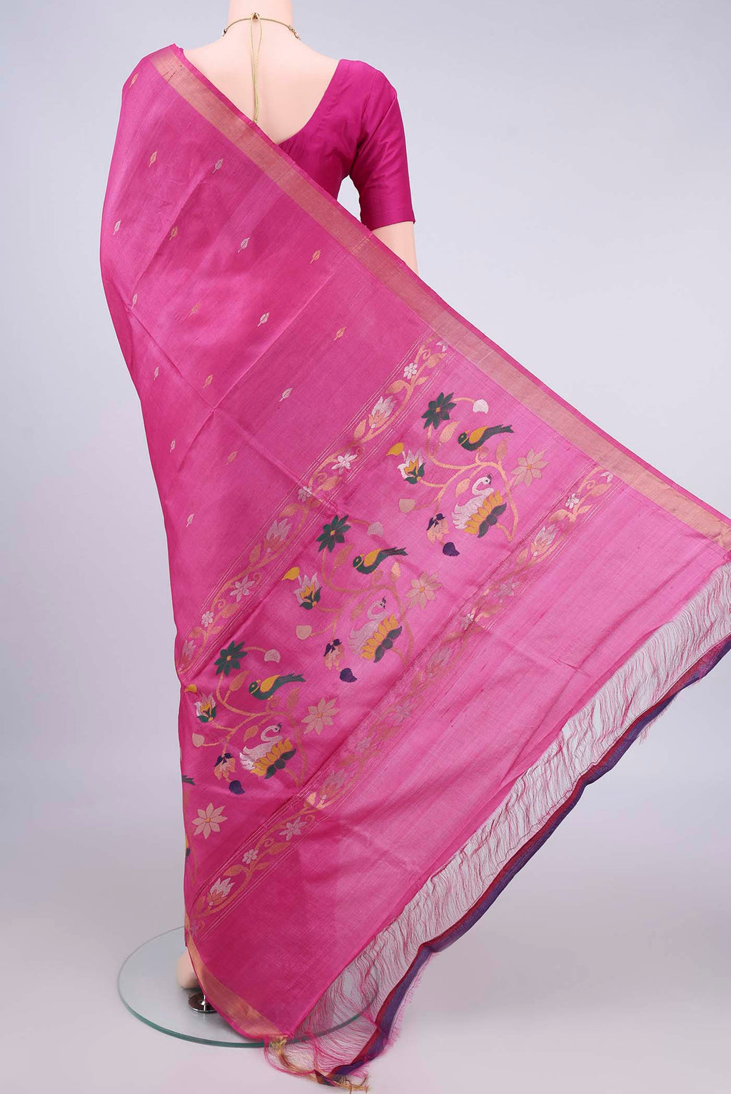 Flat view of Rani Pink Tussar Saree with Zari Butta on the body and Zari Border. 