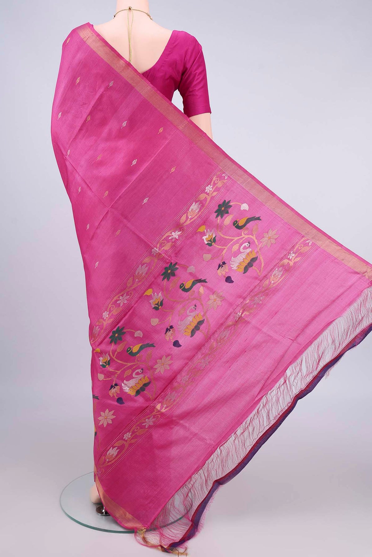 Flat view of Rani Pink Tussar Saree with Zari Butta on the body and Zari Border. 