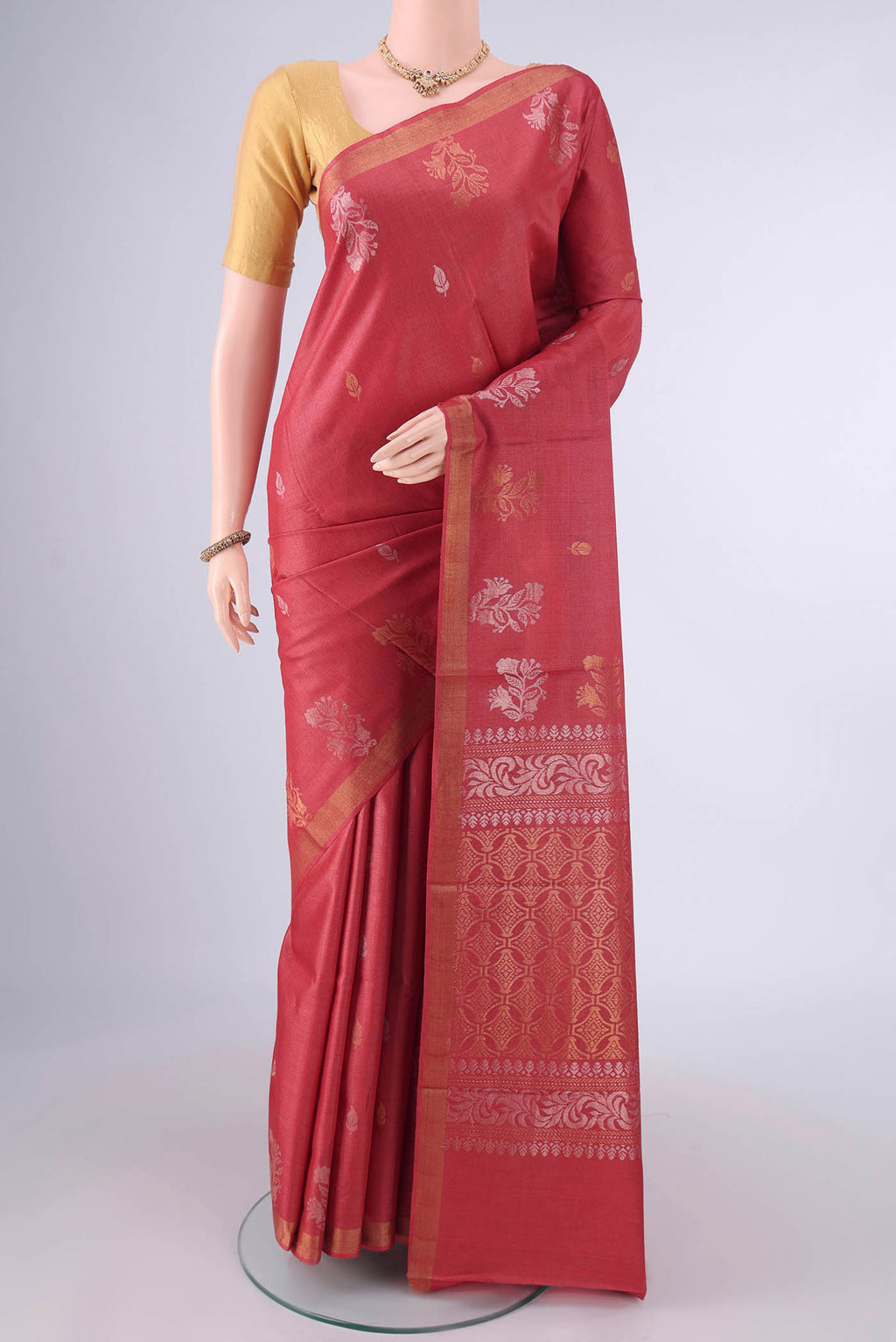 Rust MP Tussar Saree with Zari Butta on the body and Temple Border.  displayed on a mannequin