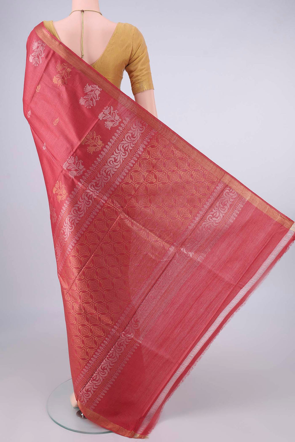 Flat view of Rust MP Tussar Saree with Zari Butta on the body and Temple Border. 