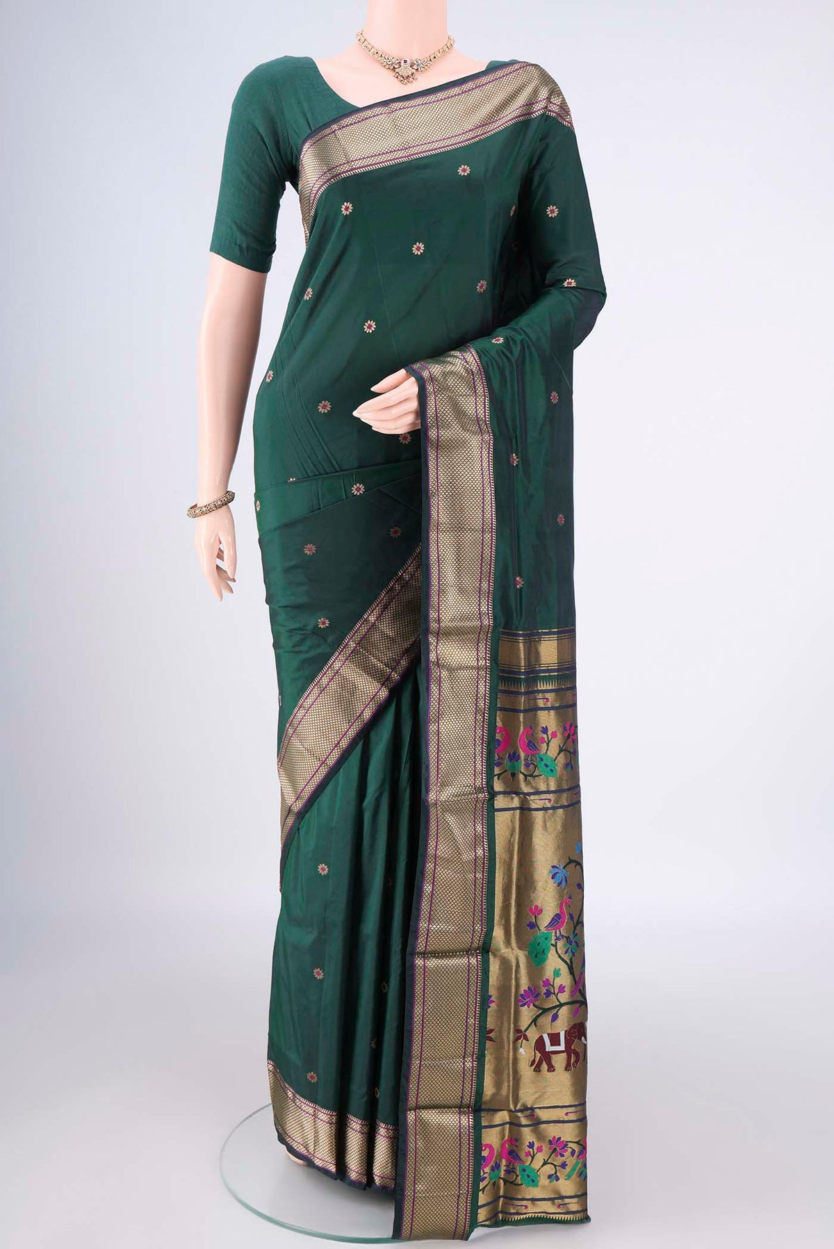 Bottle Green Blended Paithani Silk Saree with Zari And Thread Butta on the body and Zari Border.  displayed on a mannequin