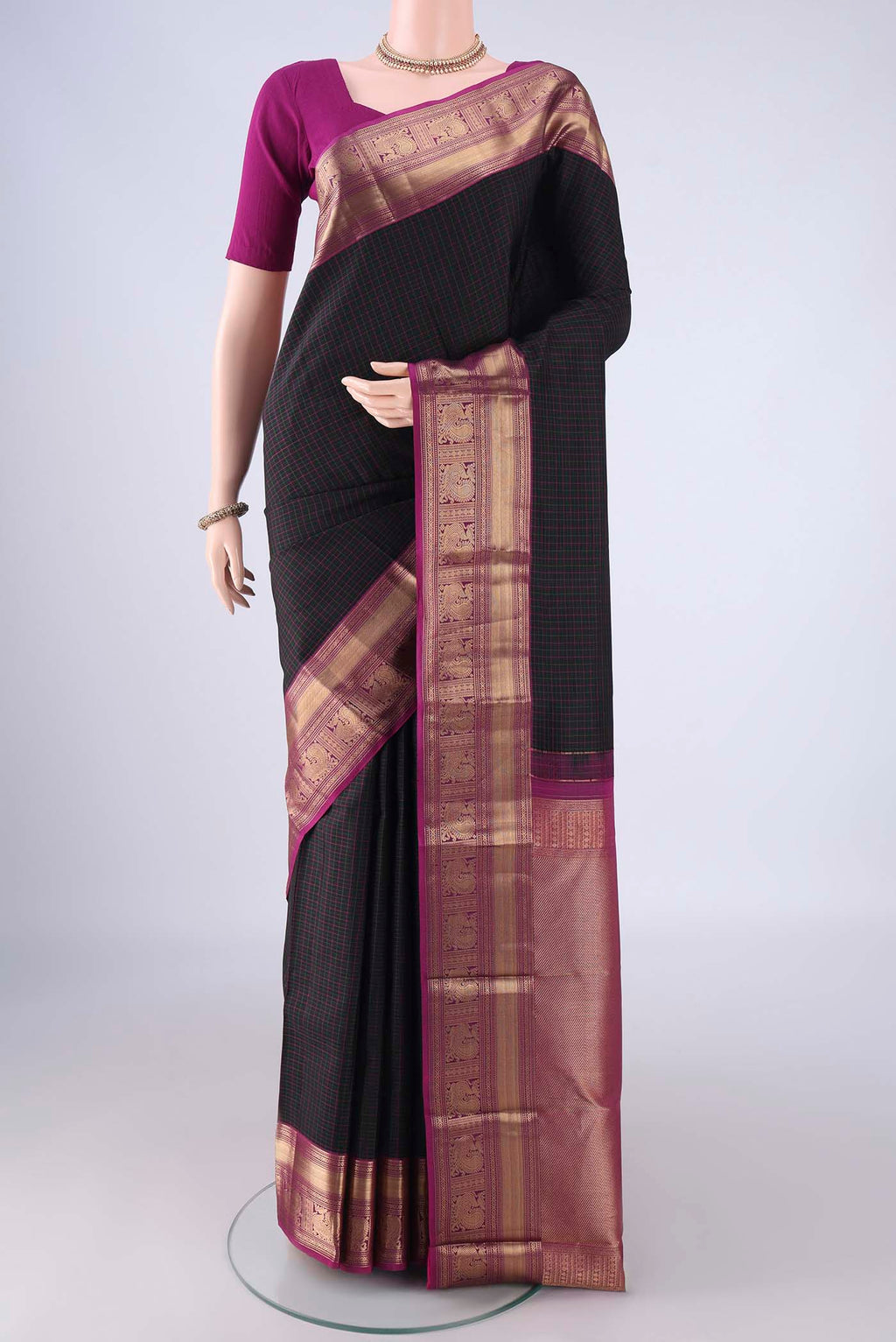 Black Kanchipuram Silk Saree with Checked design on the body and Zari Border.  displayed on a mannequin