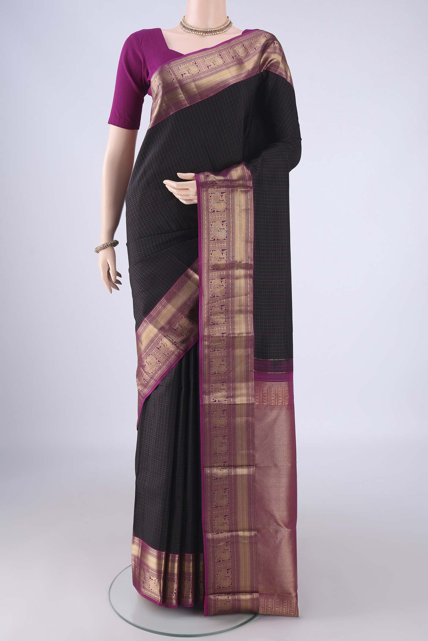 Black Kanchipuram Silk Saree with Checked design on the body and Zari Border.  displayed on a mannequin