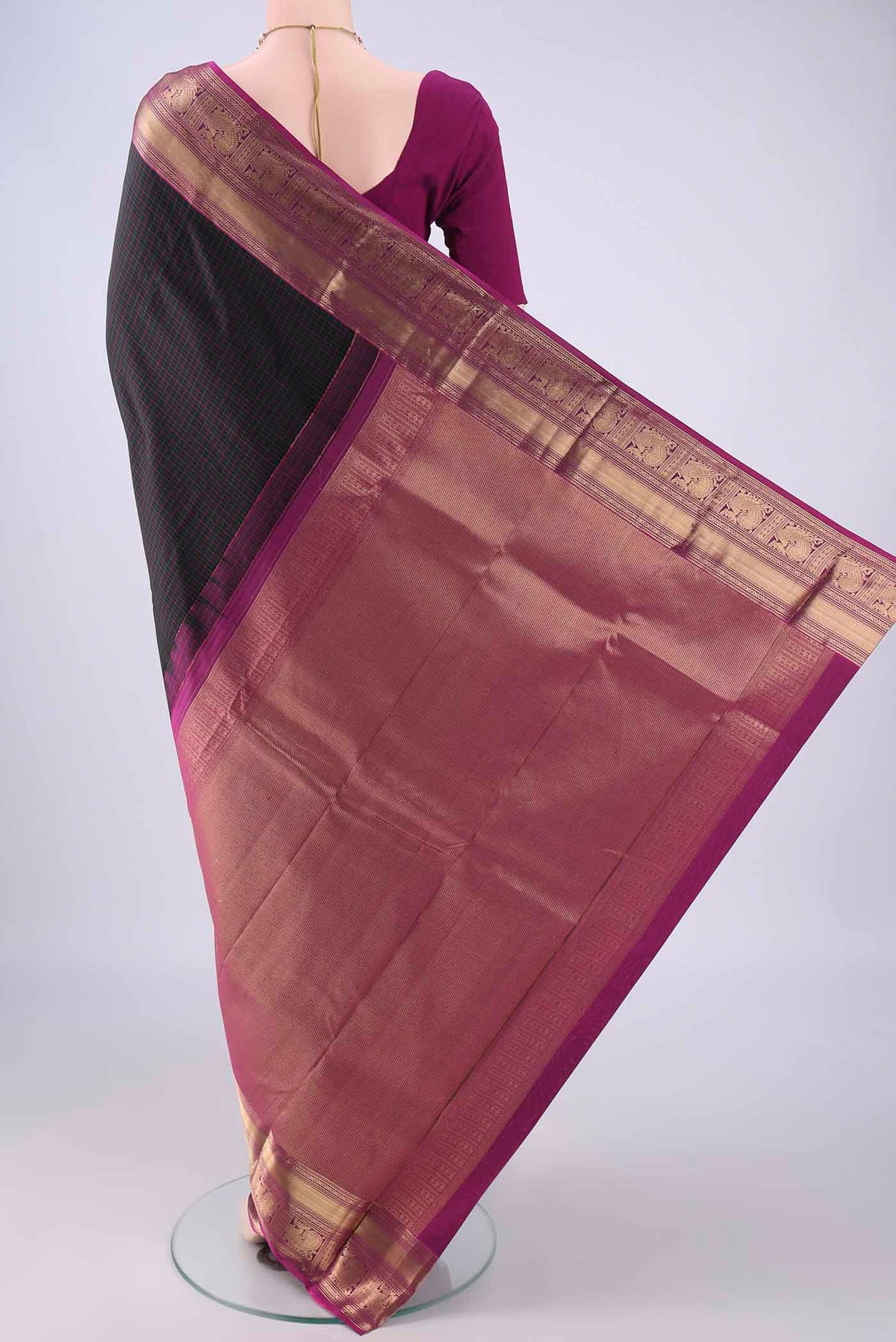 Flat view of Black Kanchipuram Silk Saree with Checked design on the body and Zari Border. 