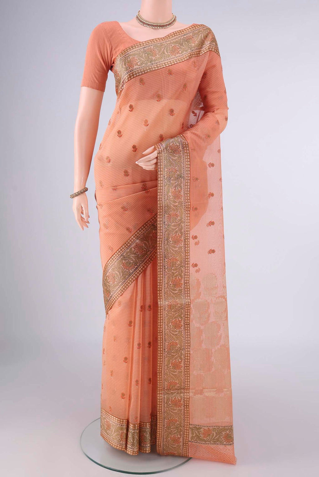 Orange Blended Kota Cotton Saree with Embroidery on the body and Zari And Thread Border.  displayed on a mannequin