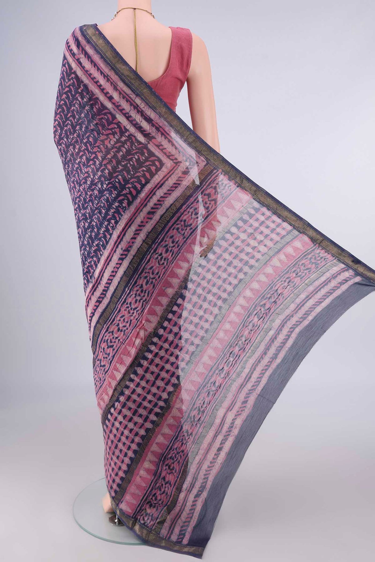Flat view of Blue Maheshwari Cotton Saree with Batik Print on the body and Zari Border. 