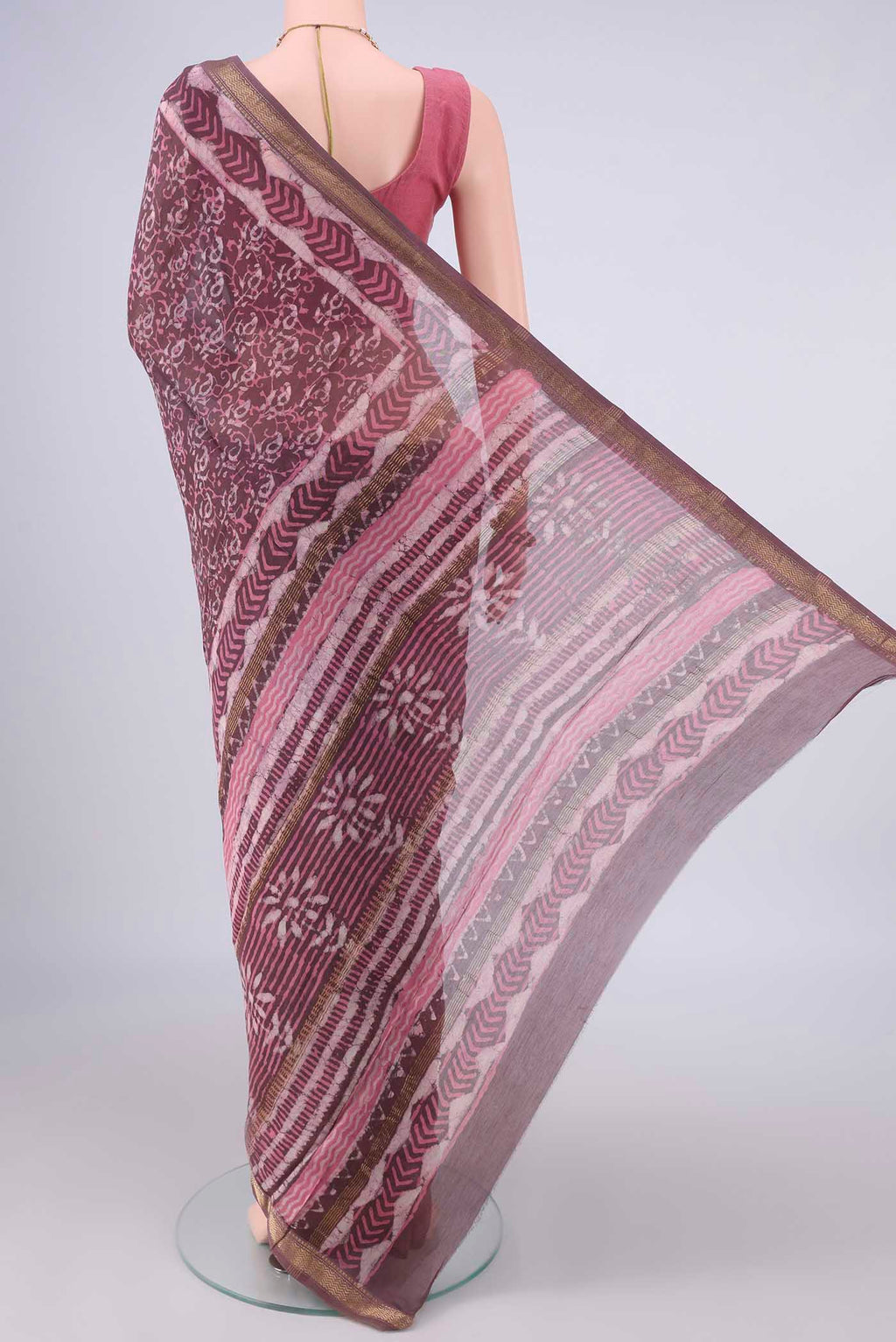 Flat view of Mauve Maheshwari Cotton Saree with Batik Print on the body and Zari Border. 