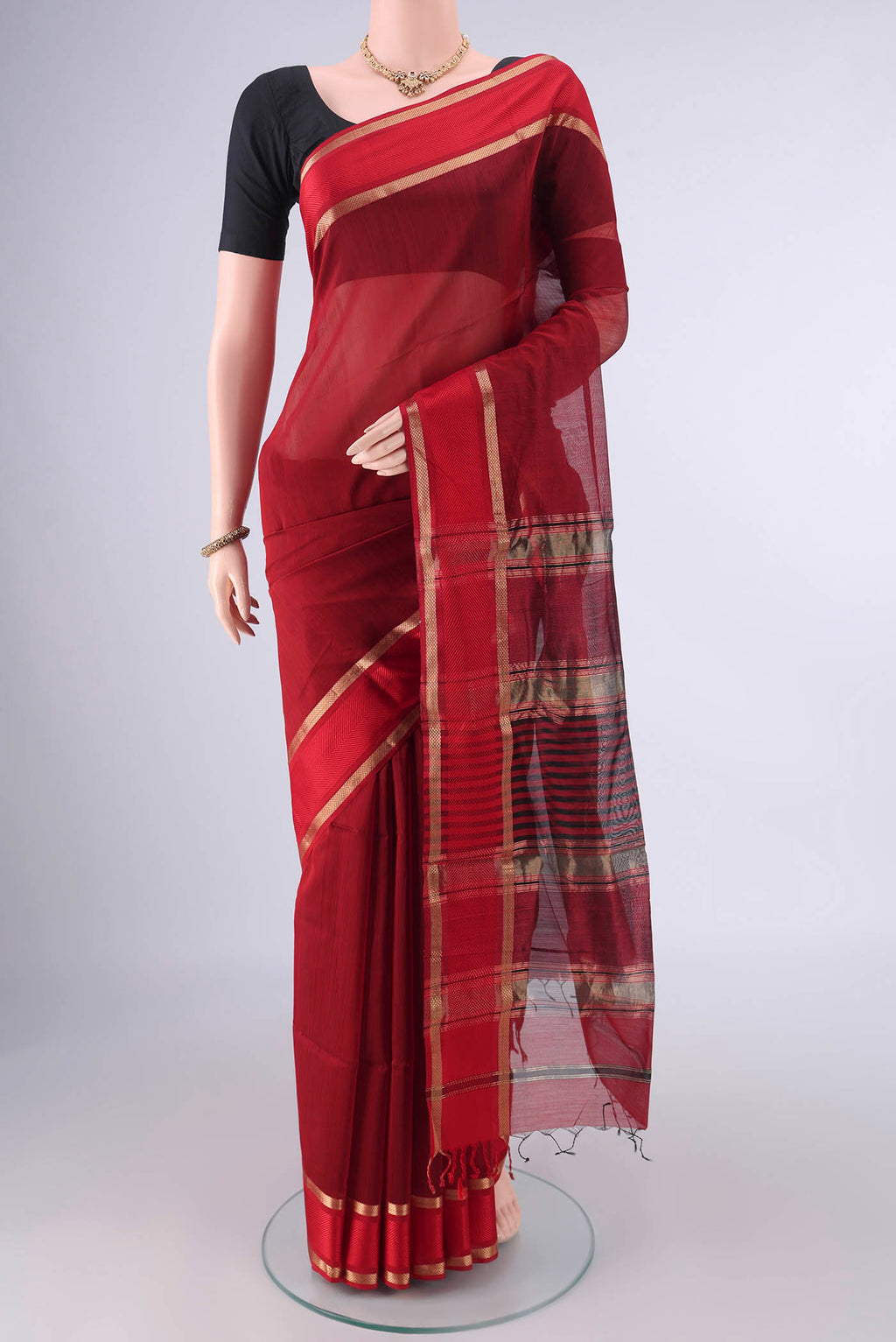 Maroon Maheshwari Cotton Saree with Plain Body and Zari Border.  displayed on a mannequin