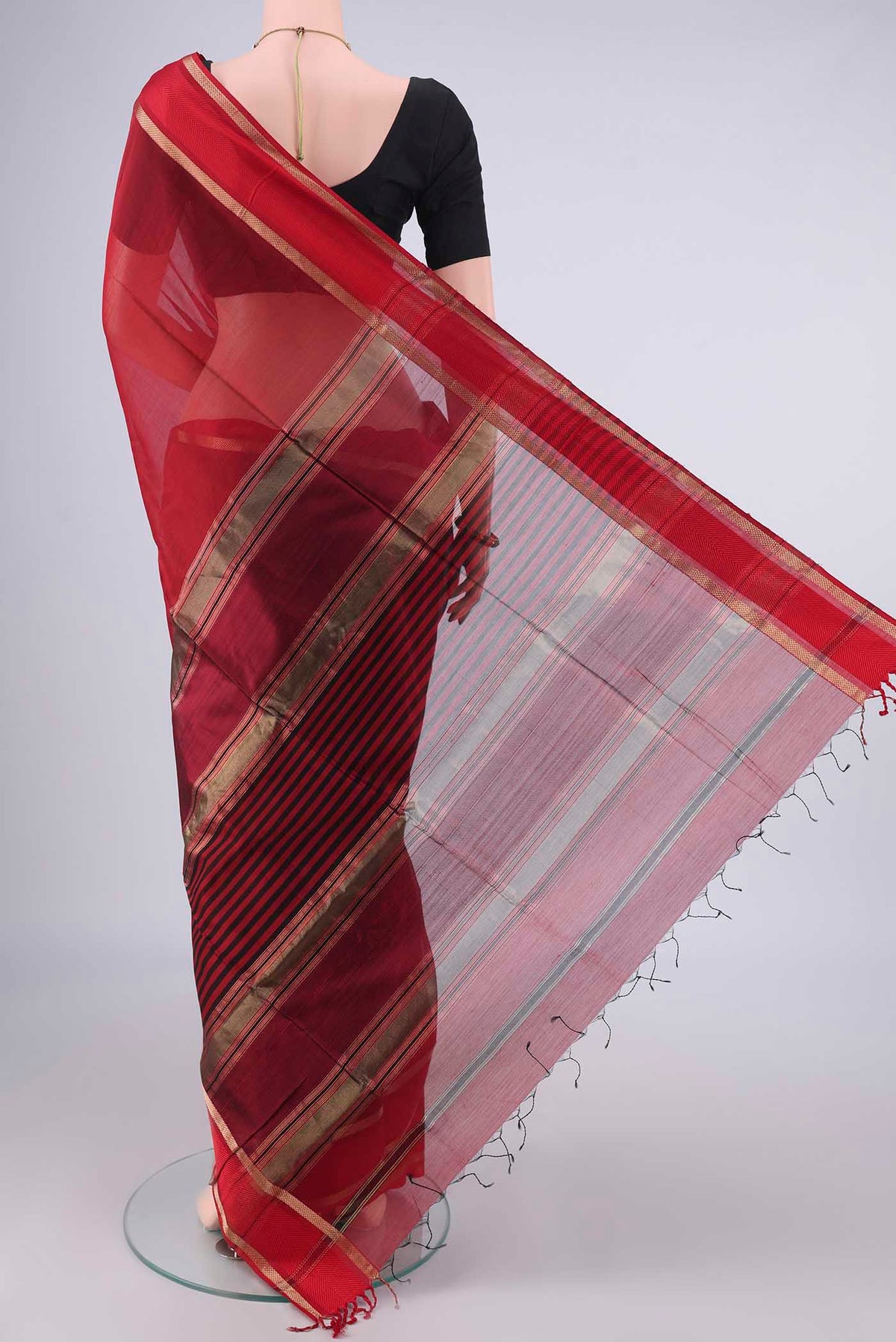 Flat view of Maroon Maheshwari Cotton Saree with Plain Body and Zari Border. 