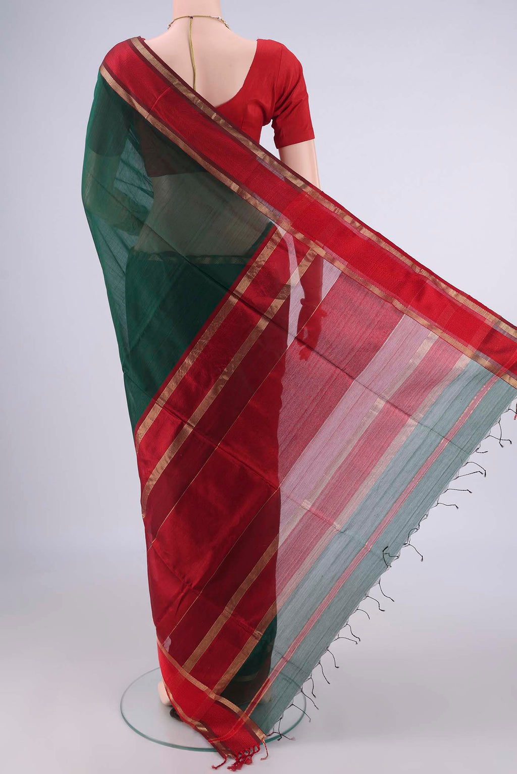 Flat view of Bottle Green Maheshwari Cotton Saree with Plain Body and Zari And Thread Border. 