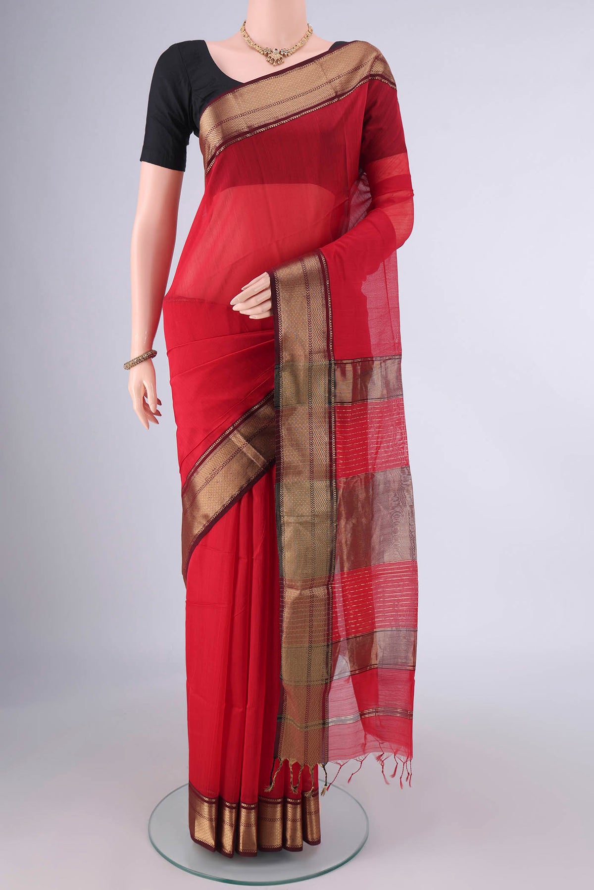 Red Maheshwari Cotton Saree with Plain Body and Zari Border.  displayed on a mannequin