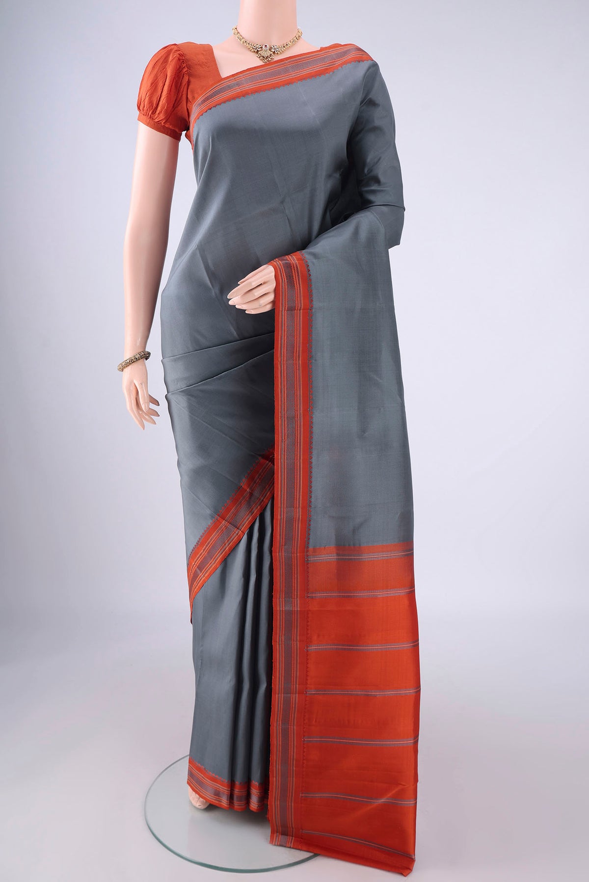 Davys Grey Kanjivaram Silk Saree with Plain Body and Thread Border.  displayed on a mannequin