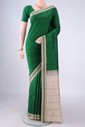 Green Kanjivaram Silk Saree with Plain Body and Thread Border.  displayed on a mannequin