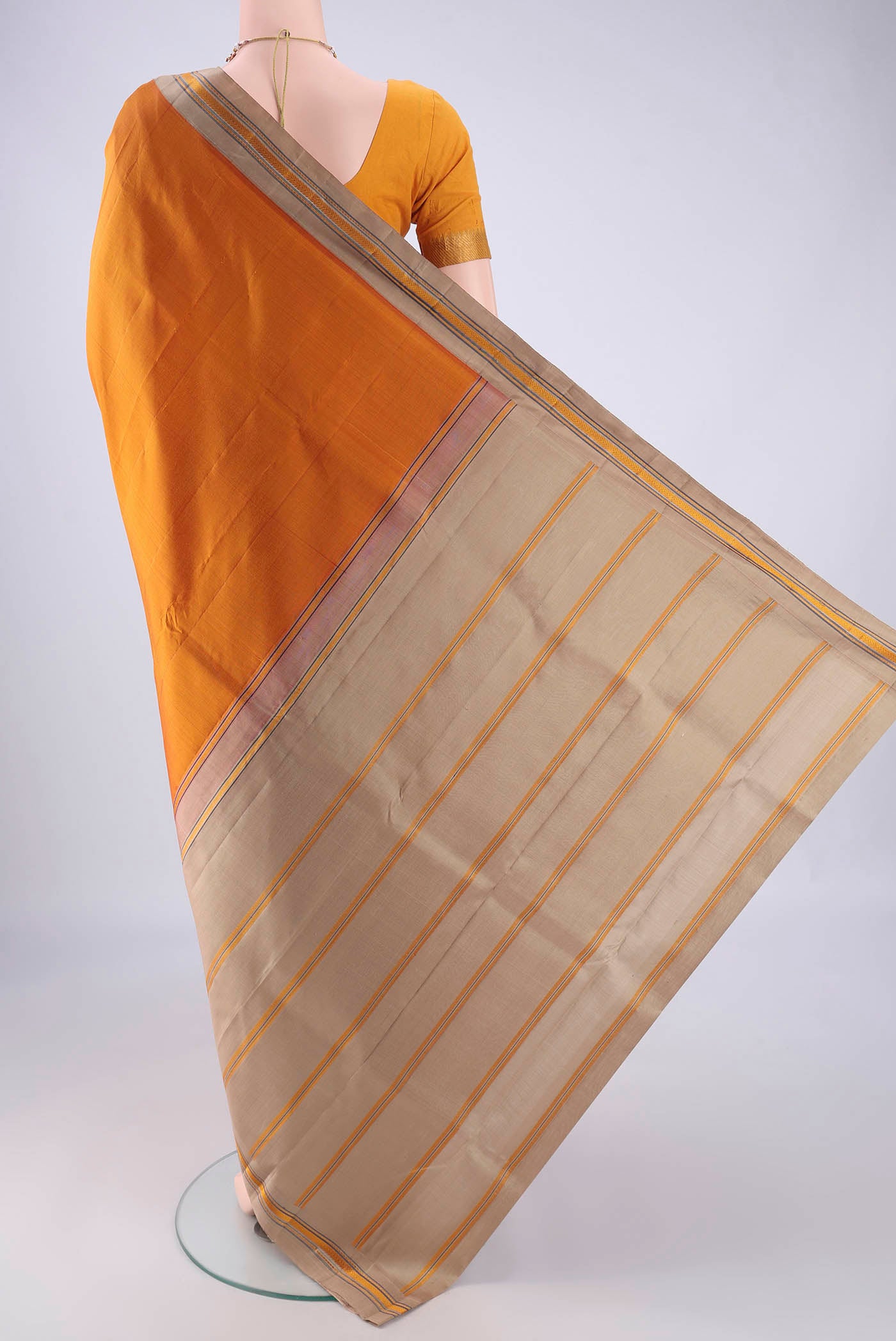 Flat view of Mustard Kanjivaram Silk Saree with Plain Body and Thread Border. 