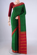 Green Kanjivaram Silk Saree with Plain Body and Thread Border.  displayed on a mannequin
