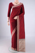 Maroon Kanjivaram Silk Saree with Plain Body and Thread Border.  displayed on a mannequin