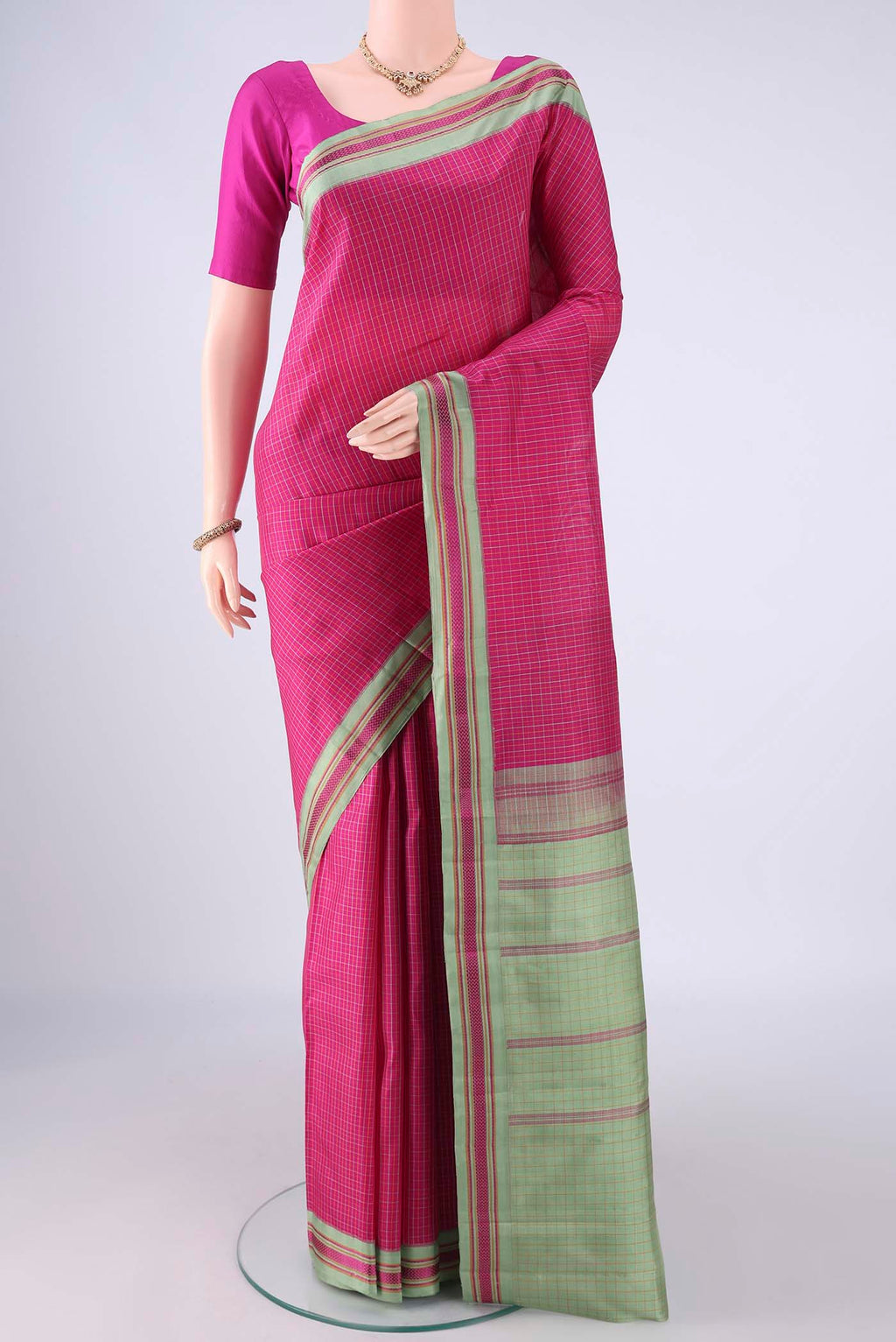 Rani Pink Kanjivaram Silk Saree with Checked design on the body and Thread Border.  displayed on a mannequin