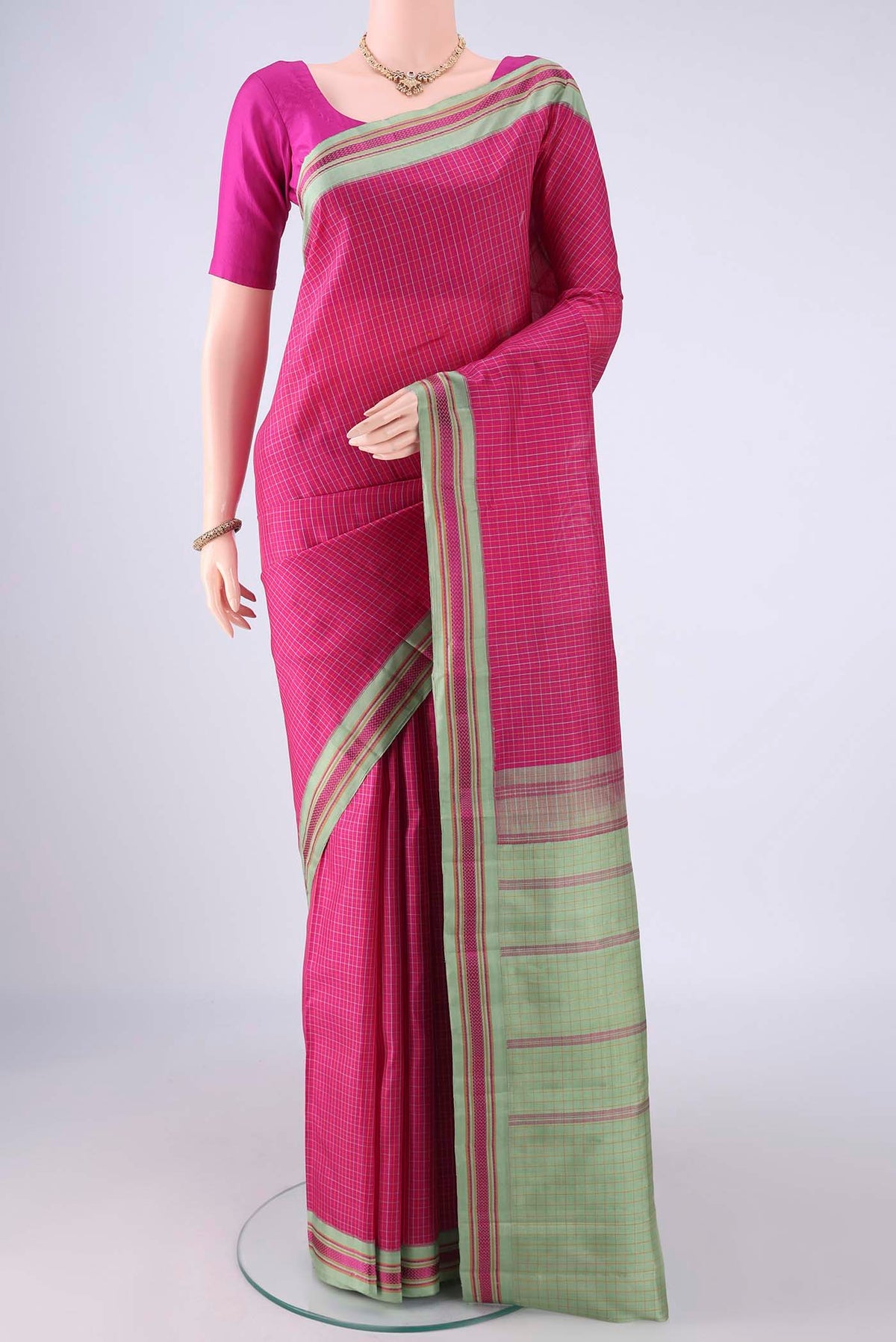 Rani Pink Kanjivaram Silk Saree with Checked design on the body and Thread Border.  displayed on a mannequin