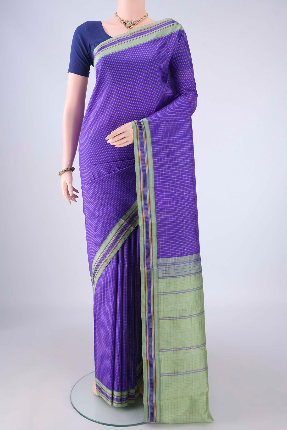 Violet Kanjivaram Silk Saree with Checked design on the body and Thread Border.  displayed on a mannequin