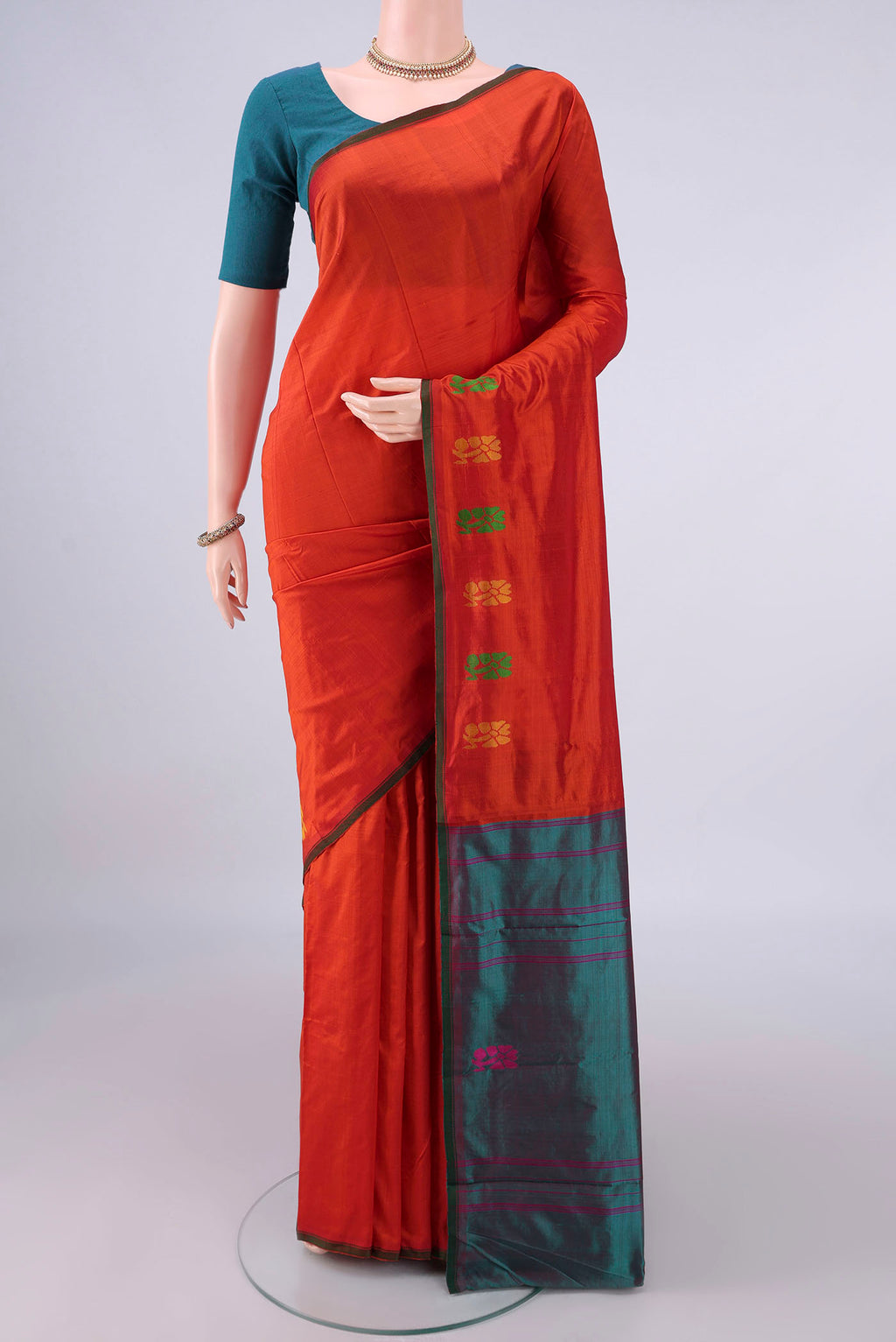 Pure Silk Orange Kanchipuram Saree with Plain Body and Thread Border.  displayed on a mannequin