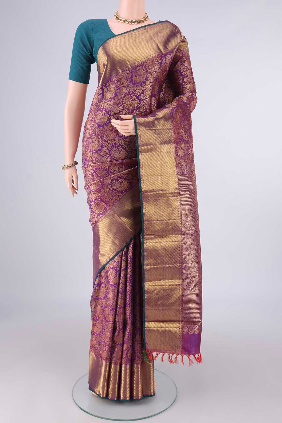 Pure Silk Pure Zari Purple Kanjivaram Saree with Zari Brocade on the body and Zari Border.  displayed on a mannequin