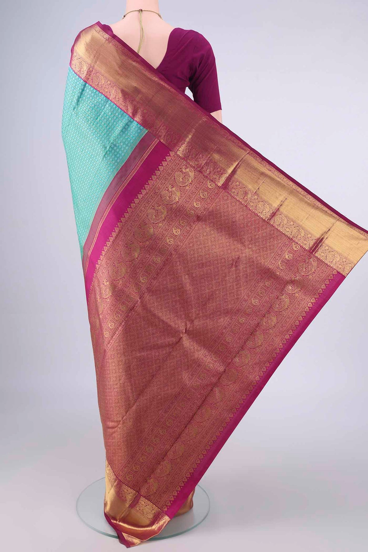 Flat view of Pure Silk Pure Zari Turquoise Kanjivaram Saree with Jacquard design on the body and Zari Border. 