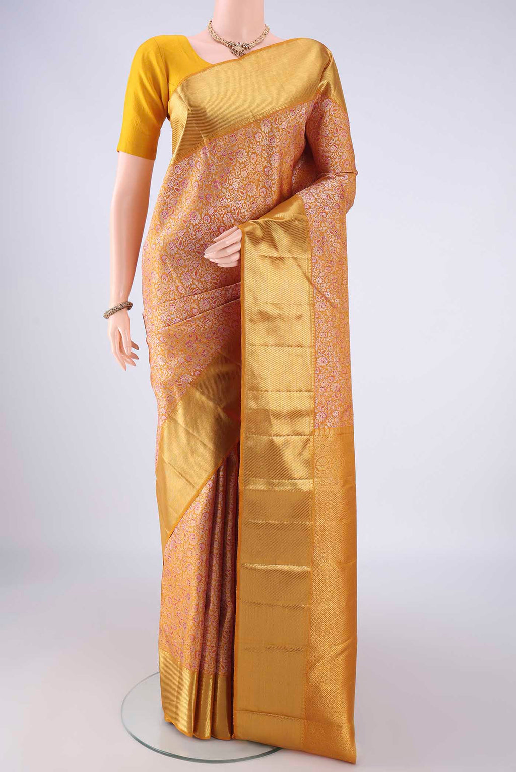Pure Silk Pure Zari Mustard Kanjivaram Saree with Zari Brocade on the body and Zari Border.  displayed on a mannequin
