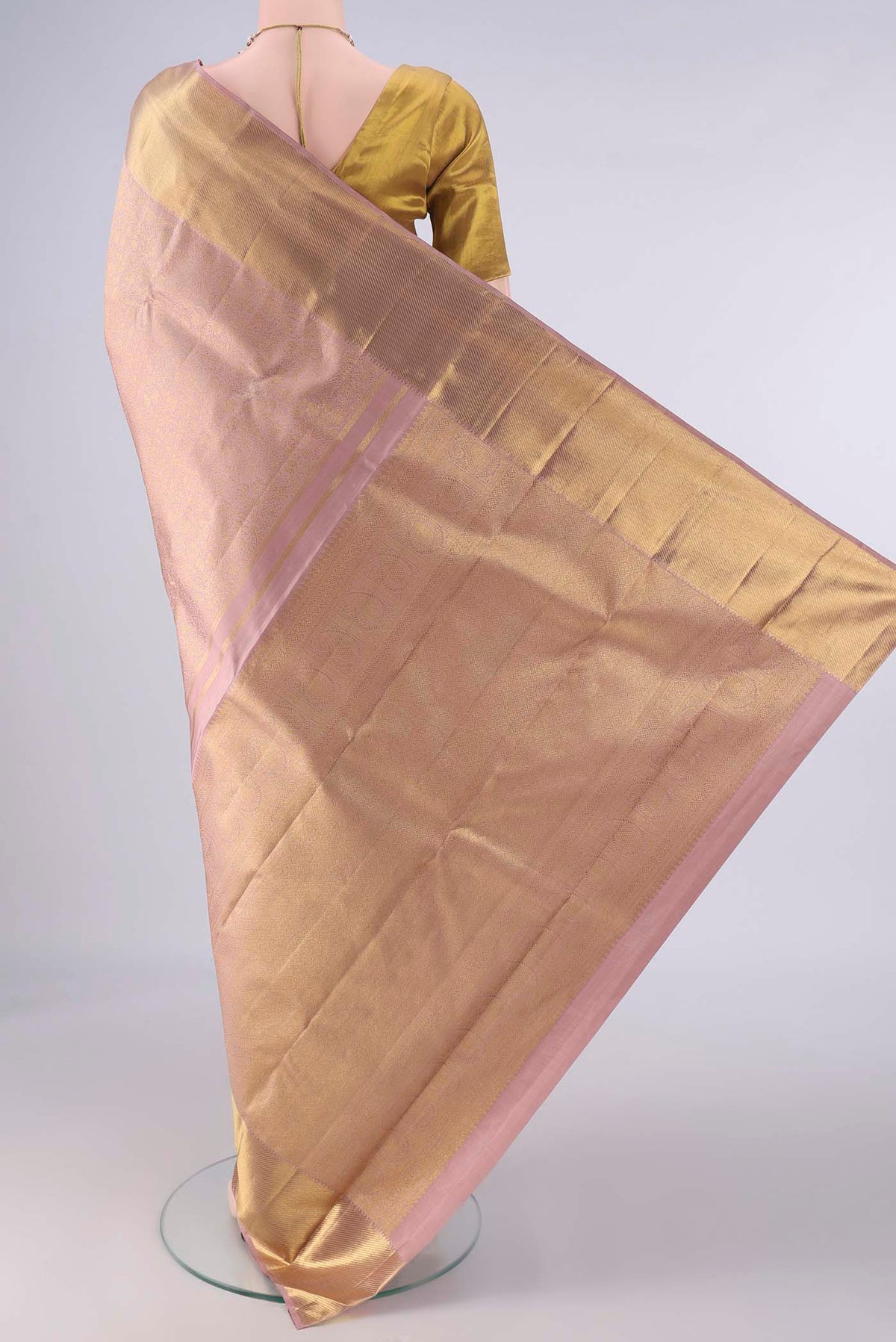 Flat view of Pure Silk Pure Zari Rose Gold Kanjivaram Saree with Zari Brocade on the body and Zari Border. 