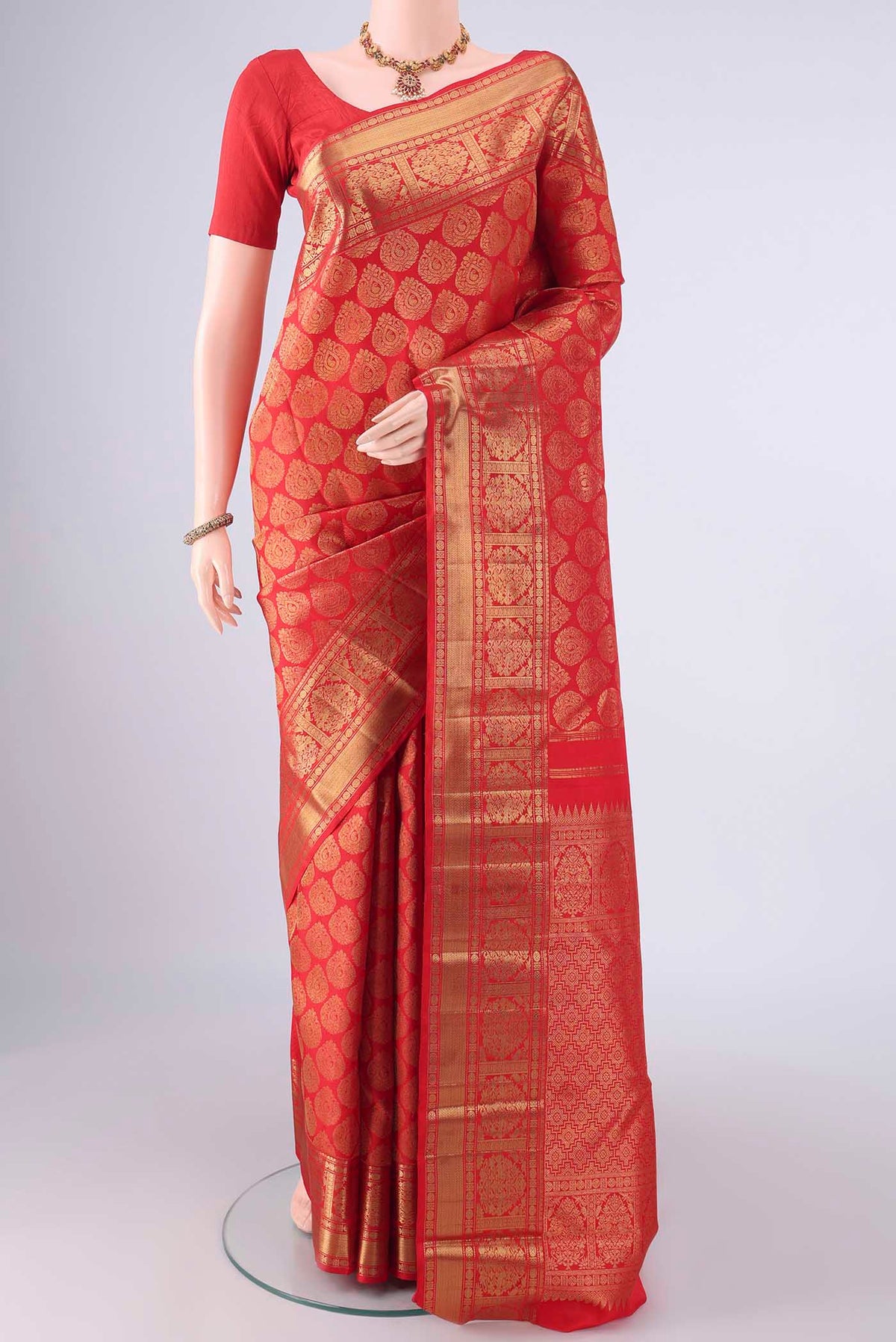 Pure Silk Pure Zari Red Kanjivaram Saree with Zari Brocade on the body and Zari Border.  displayed on a mannequin