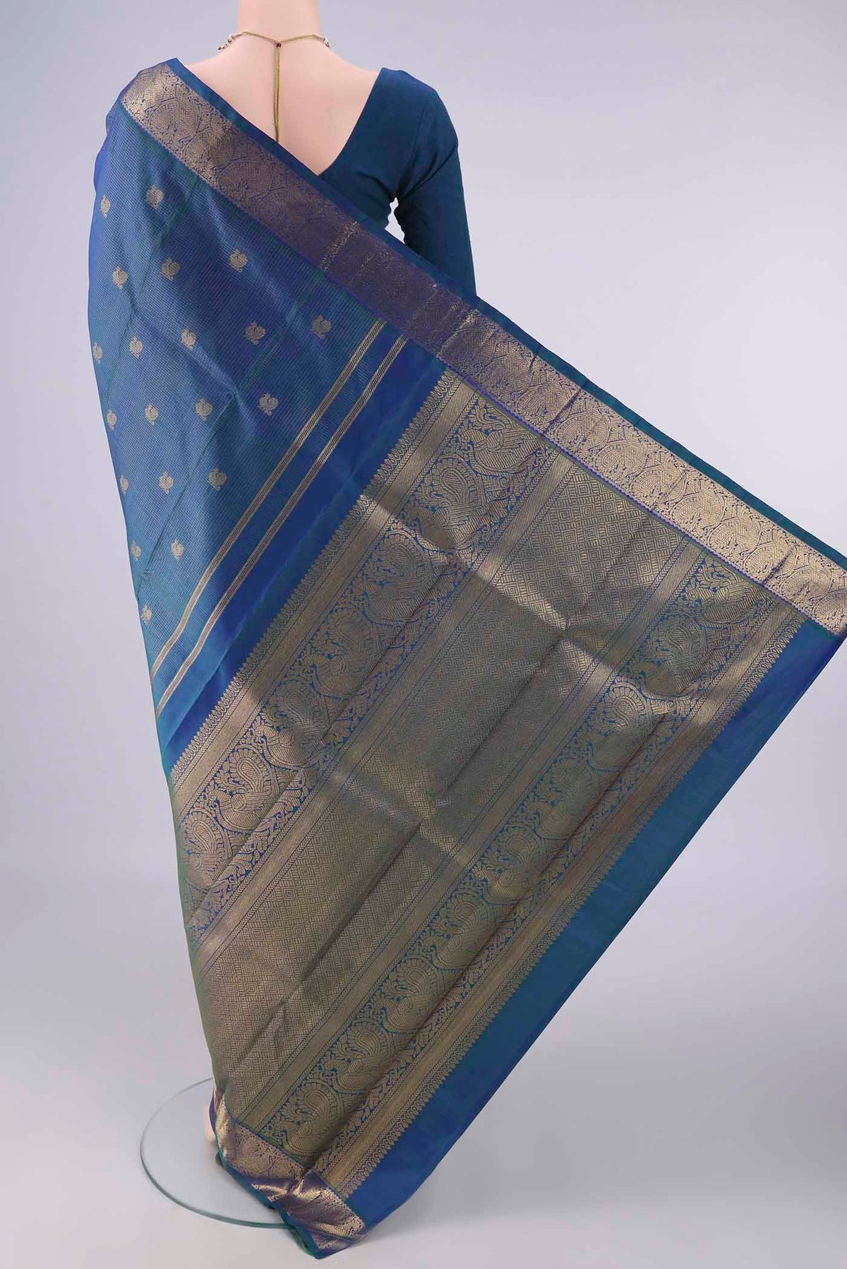 Flat view of Pure Silk Pure Zari Peacock Blue Dual Tone Kanjivaram Saree with Checked design on the body and Zari Border. 