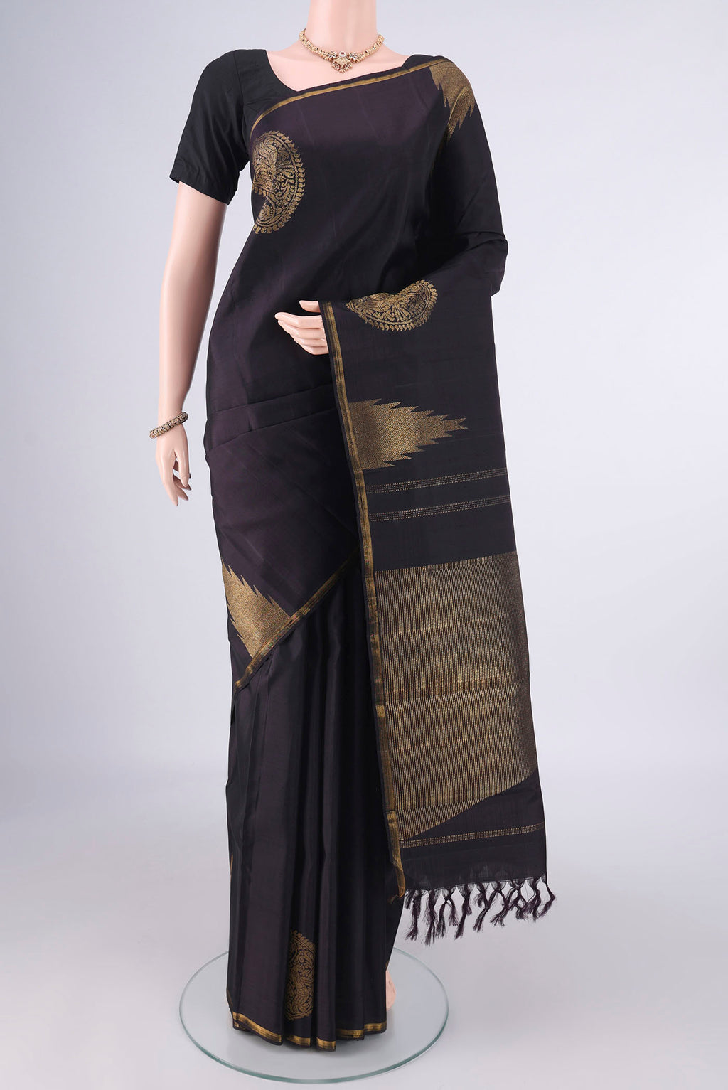 Pure Silk Pure Zari Black Kanchipuram Saree with Plain Body and Thin Zari Line.  displayed on a mannequin