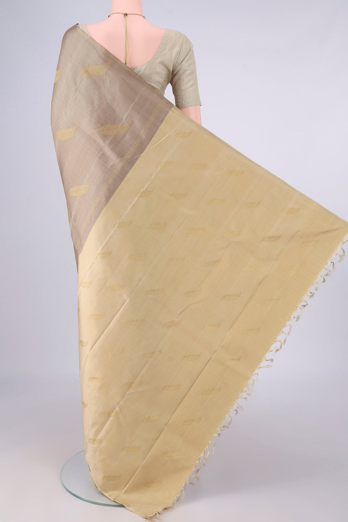 Flat view of Pure Silk Pure Zari Dark Beige Kanchipuram Saree with Zari Butta on the body and Zari Border. 