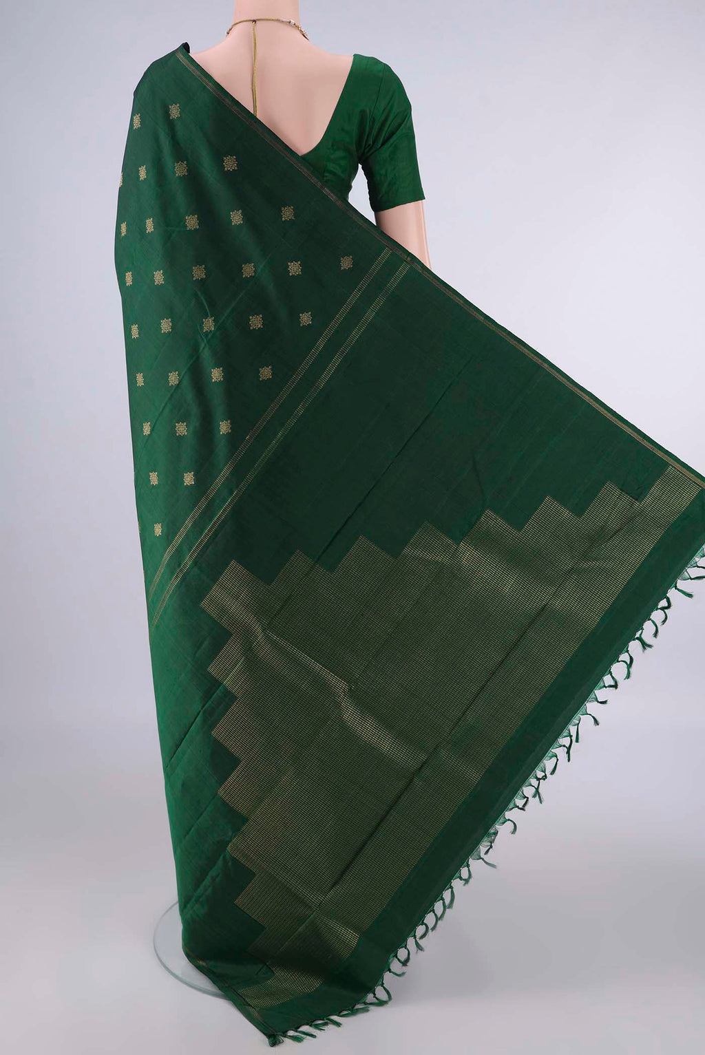 Flat view of Pure Silk Bottle Green Kanchipuram Saree with Zari Butta on the body and Thin Zari Line. 
