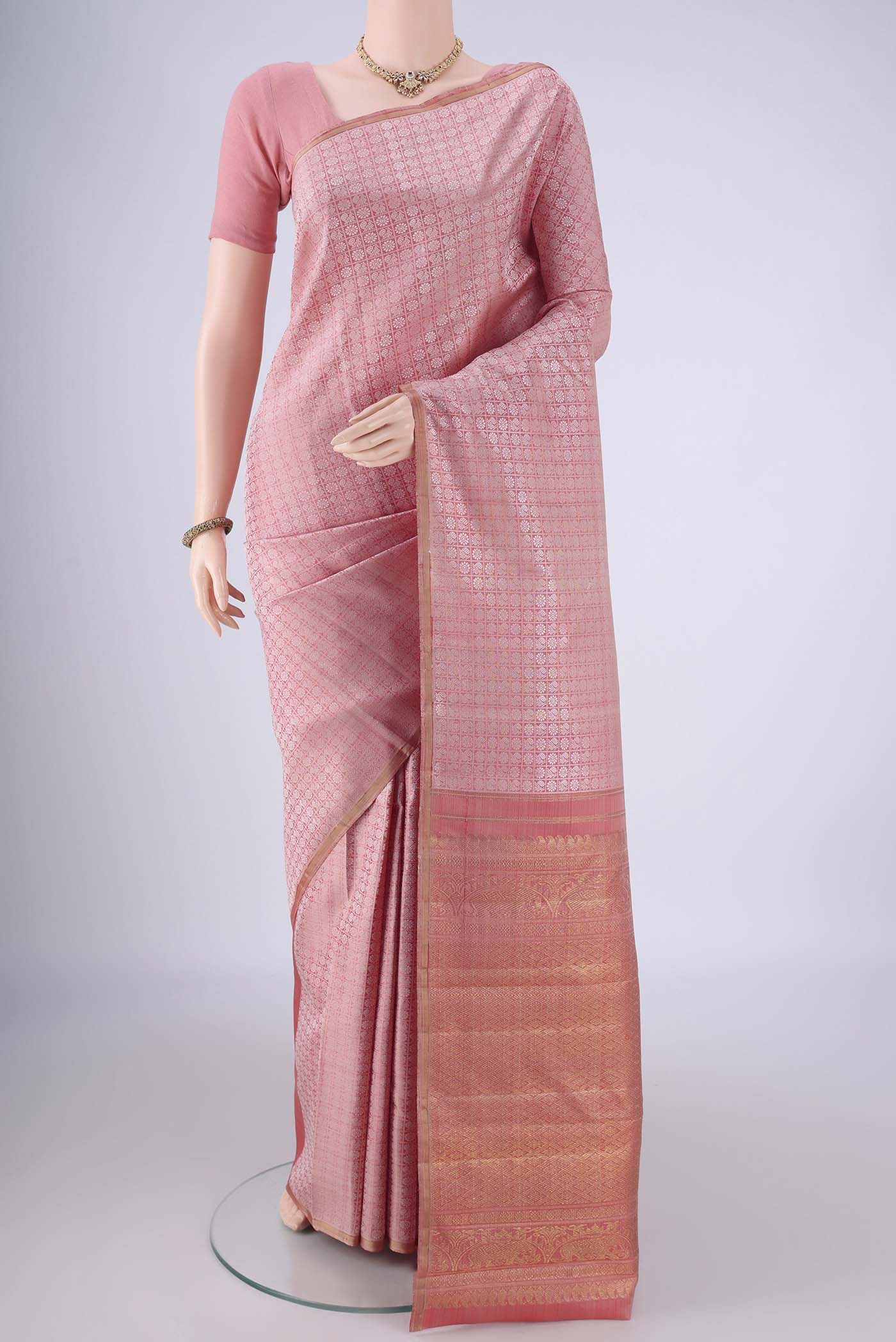 Rose Gold Kanchipuram Silk Saree with Jacquard design on the body and Without Border.  displayed on a mannequin