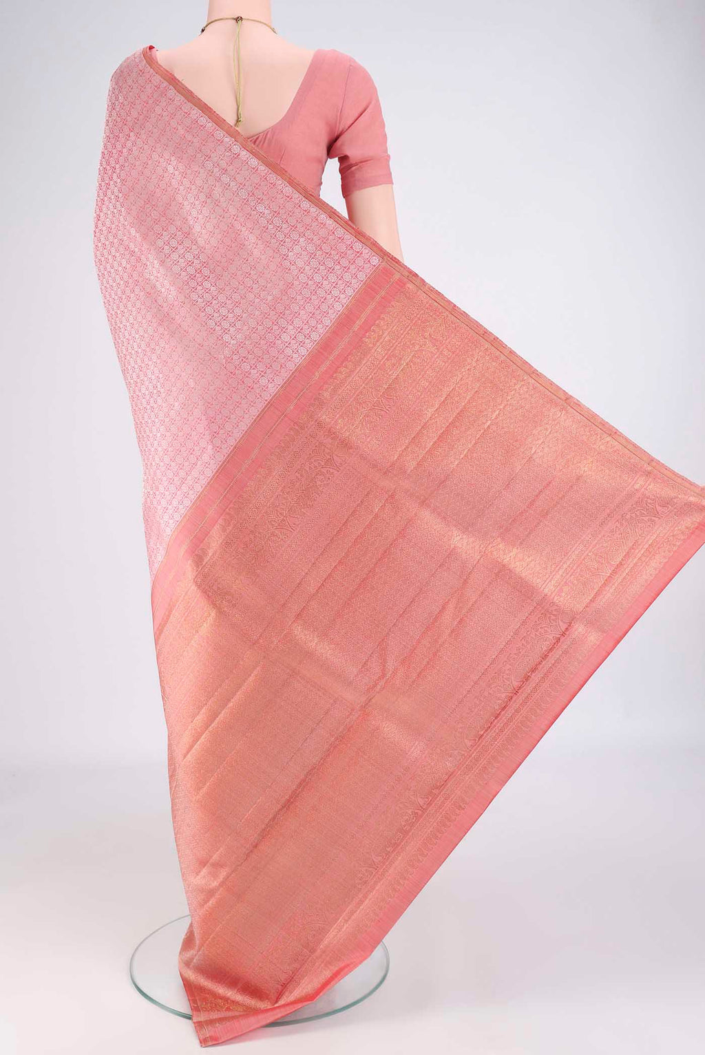 Flat view of Rose Gold Kanchipuram Silk Saree with Jacquard design on the body and Without Border. 