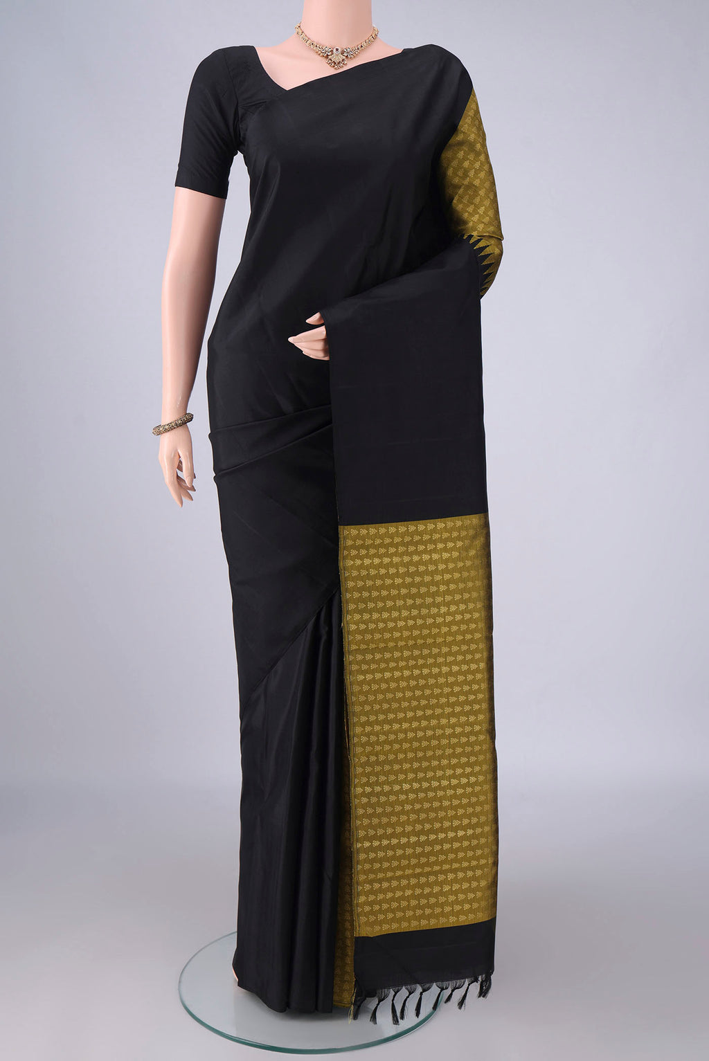 Pure Silk Black Kanchipuram Saree with Partli on the body and Without Border.  displayed on a mannequin