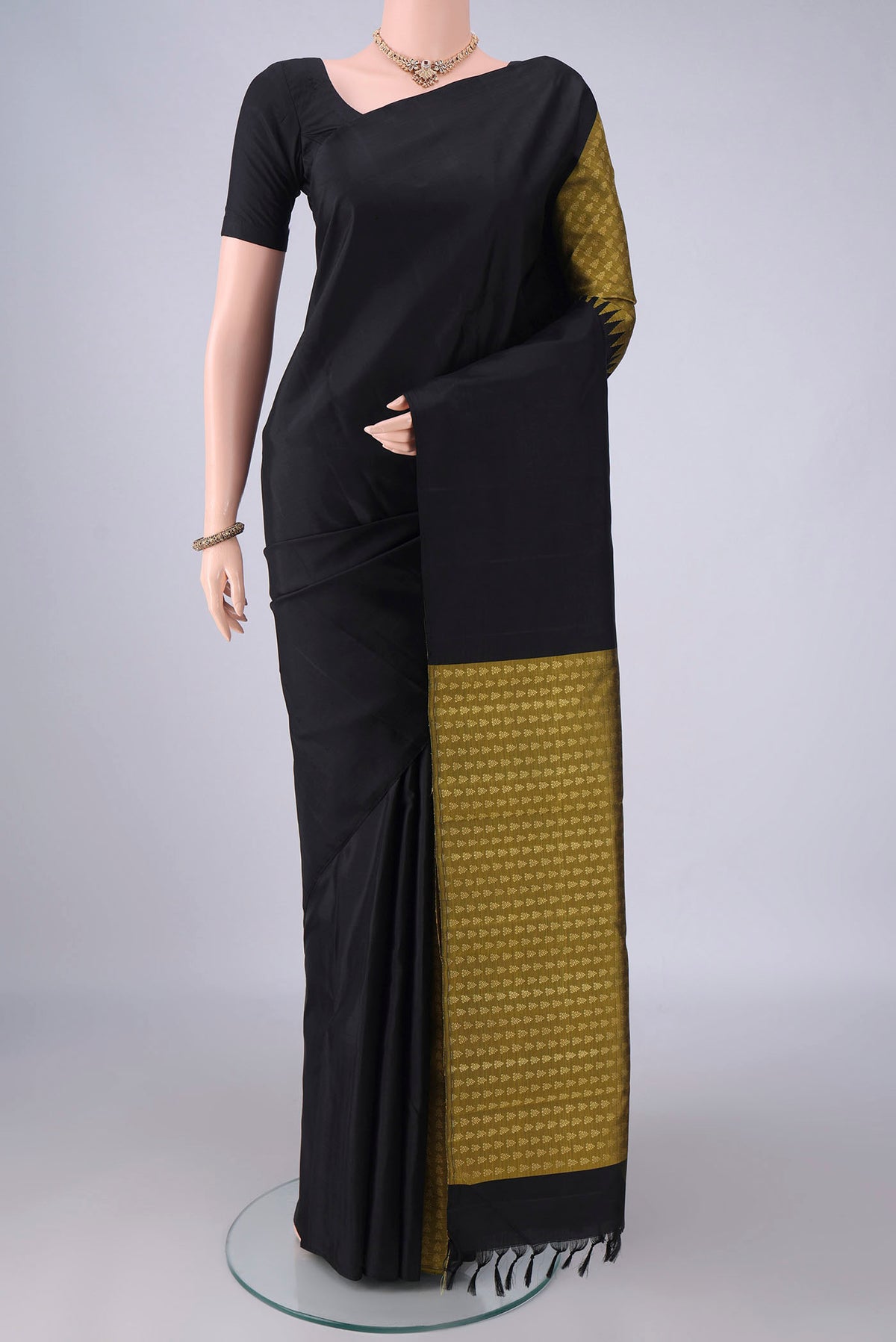 Pure Silk Black Kanchipuram Saree with Partli on the body and Without Border.  displayed on a mannequin