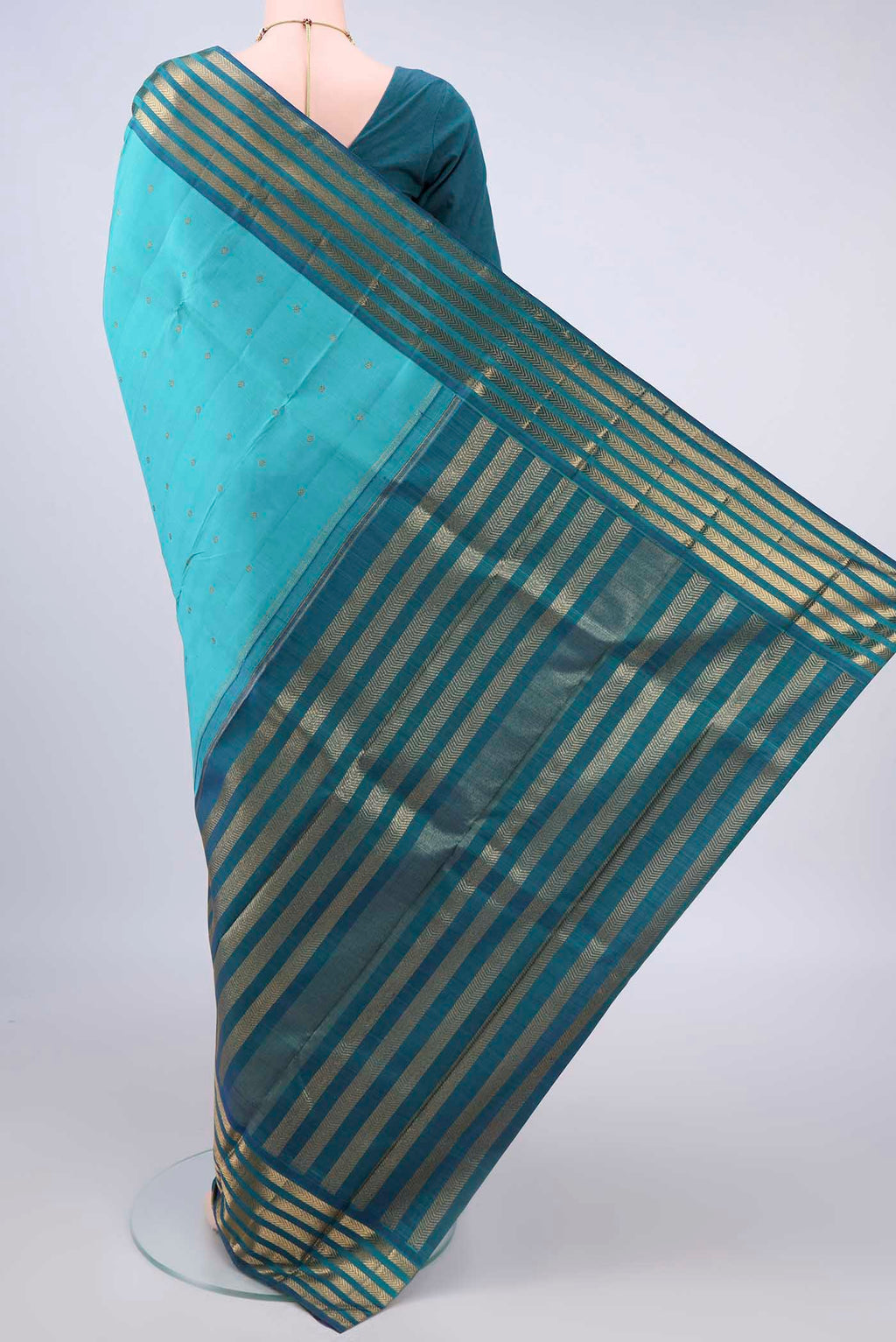 Flat view of Pure Silk Pure Zari Turquoise Kanjivaram Saree with Zari Butta on the body and Zari Border. 
