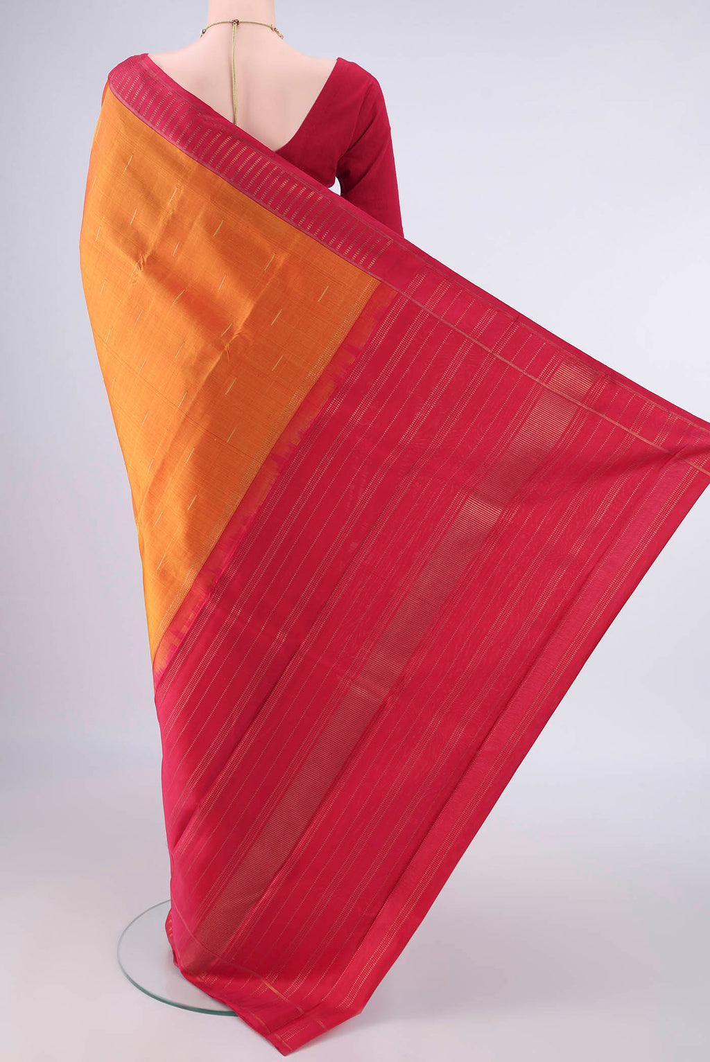 Flat view of Pure Silk Orange Kanchipuram Saree with Plain Body and Zari Border. 