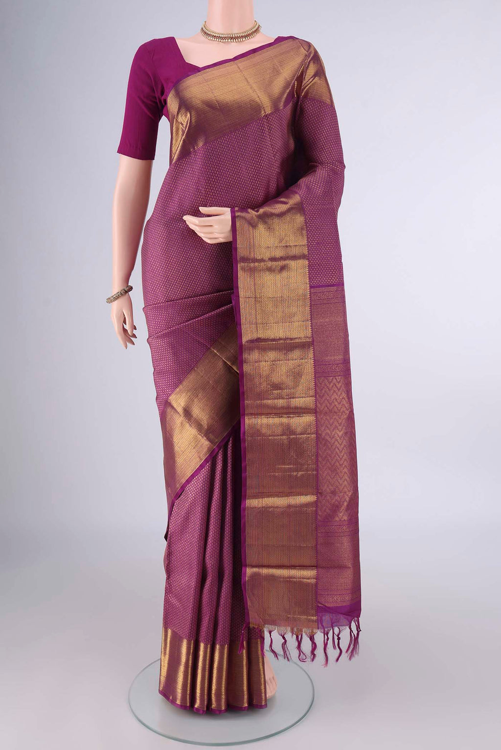 Pure Silk Magenta Kanchipuram Saree with Zari Brocade on the body and Zari Border.  displayed on a mannequin