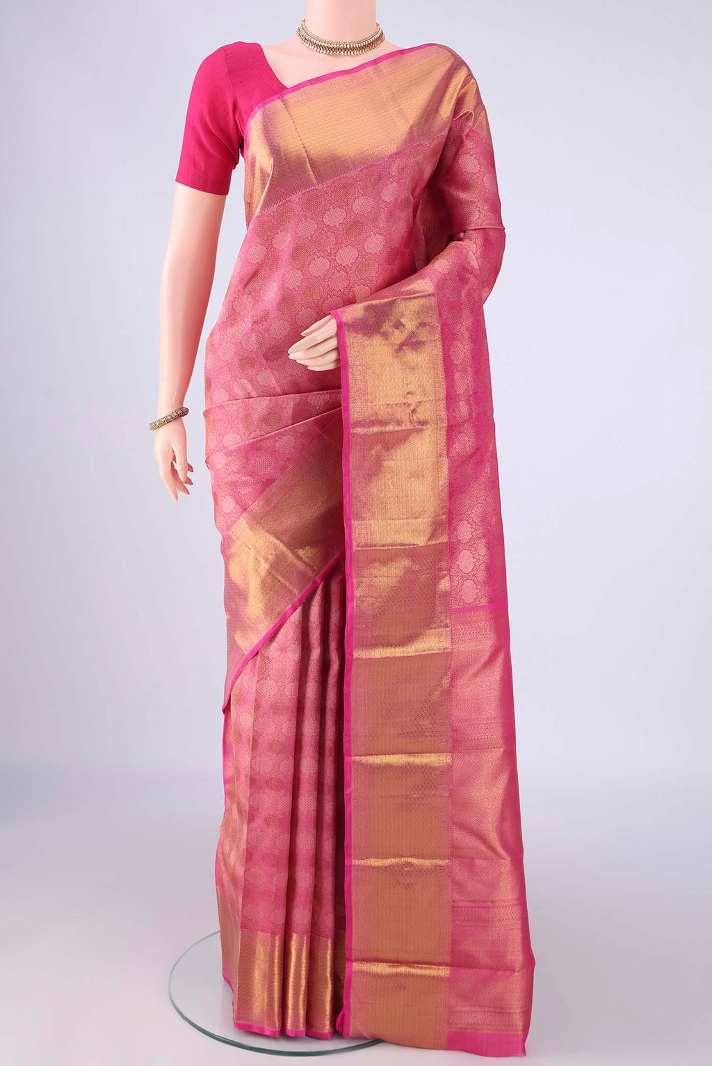 Rani Pink Kanchipuram Silk Saree with Zari Brocade on the body and Zari Border.  displayed on a mannequin