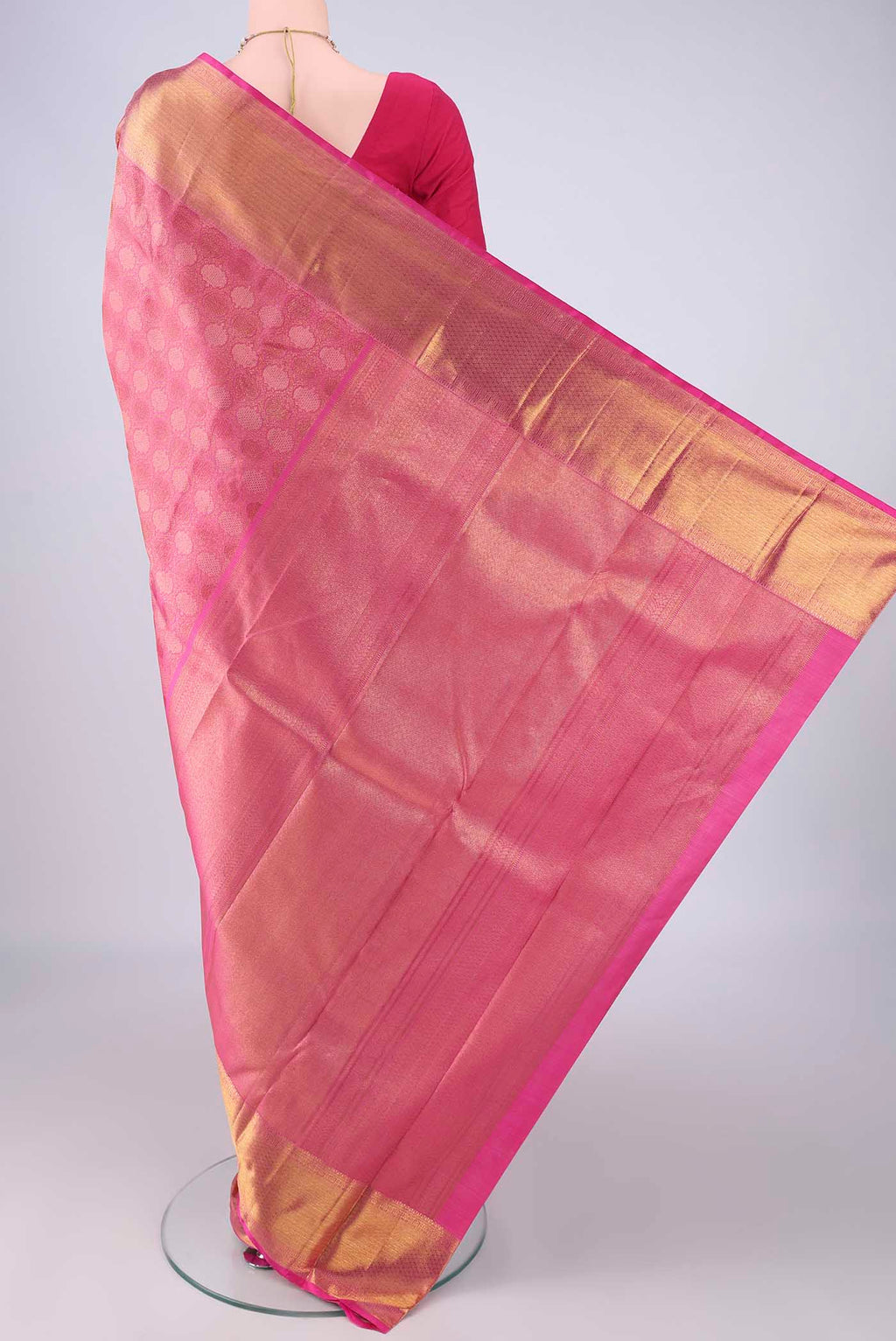 Flat view of Rani Pink Kanchipuram Silk Saree with Zari Brocade on the body and Zari Border. 