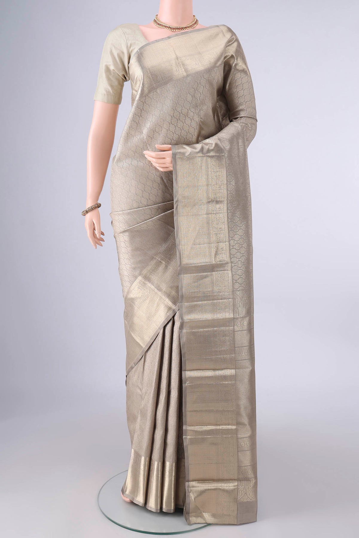 Pure Silk Grey Kanchipuram Saree with Zari Brocade on the body and Zari Border.  displayed on a mannequin