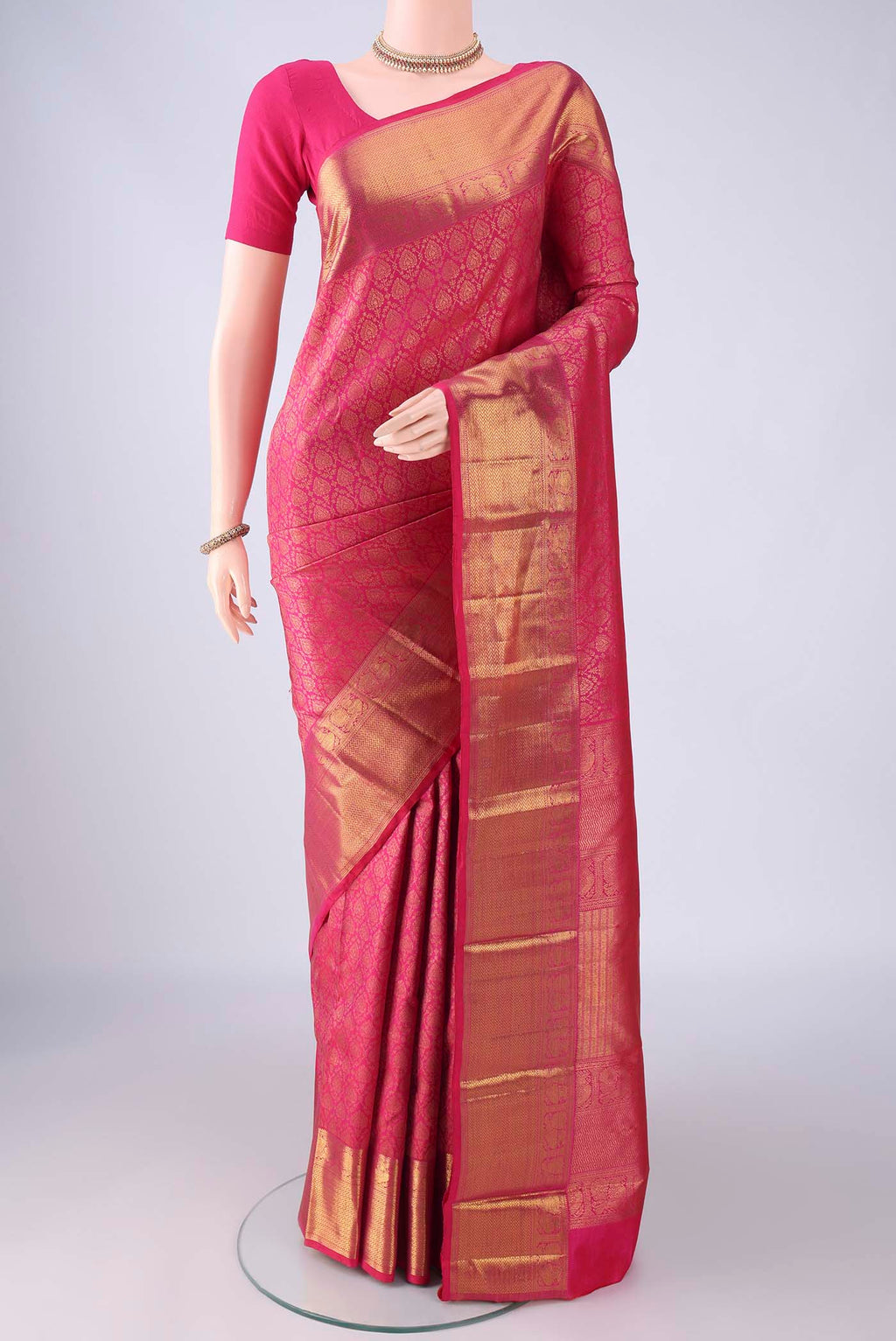 Rani Pink Kanchipuram Silk Saree with Zari Brocade on the body and Zari Border.  displayed on a mannequin