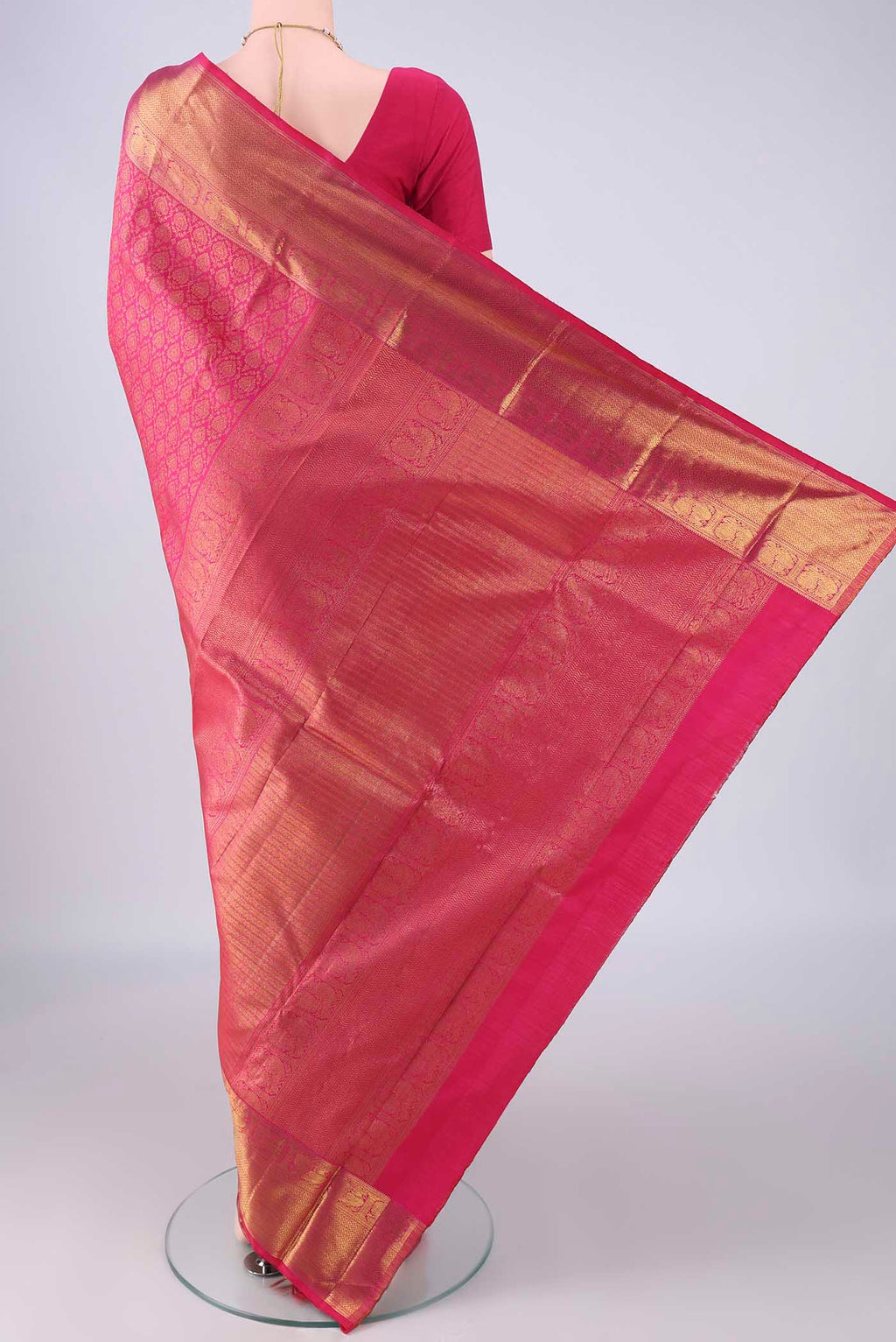 Flat view of Rani Pink Kanchipuram Silk Saree with Zari Brocade on the body and Zari Border. 