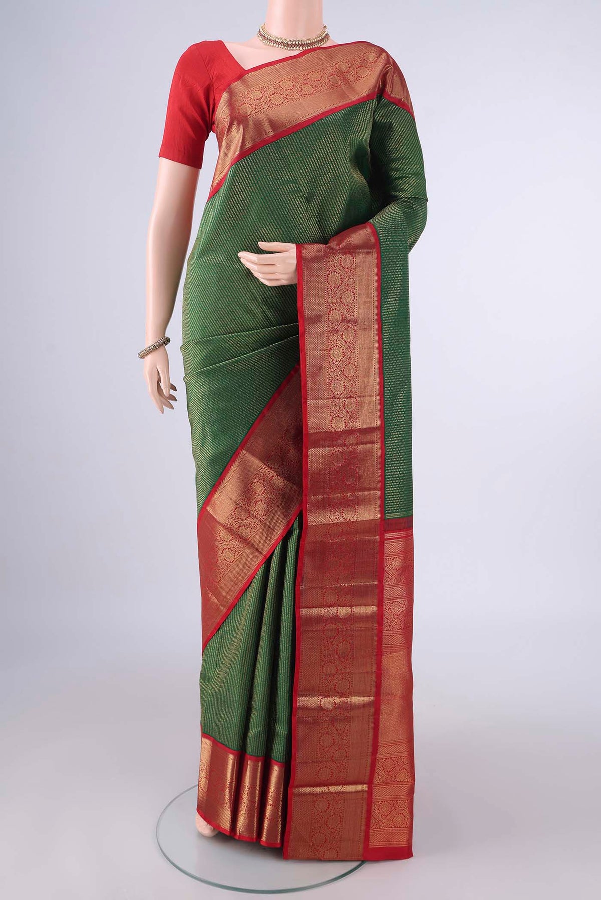 Pure Silk Green Kanjivaram Saree with Zari Brocade on the body and Zari Border.  displayed on a mannequin