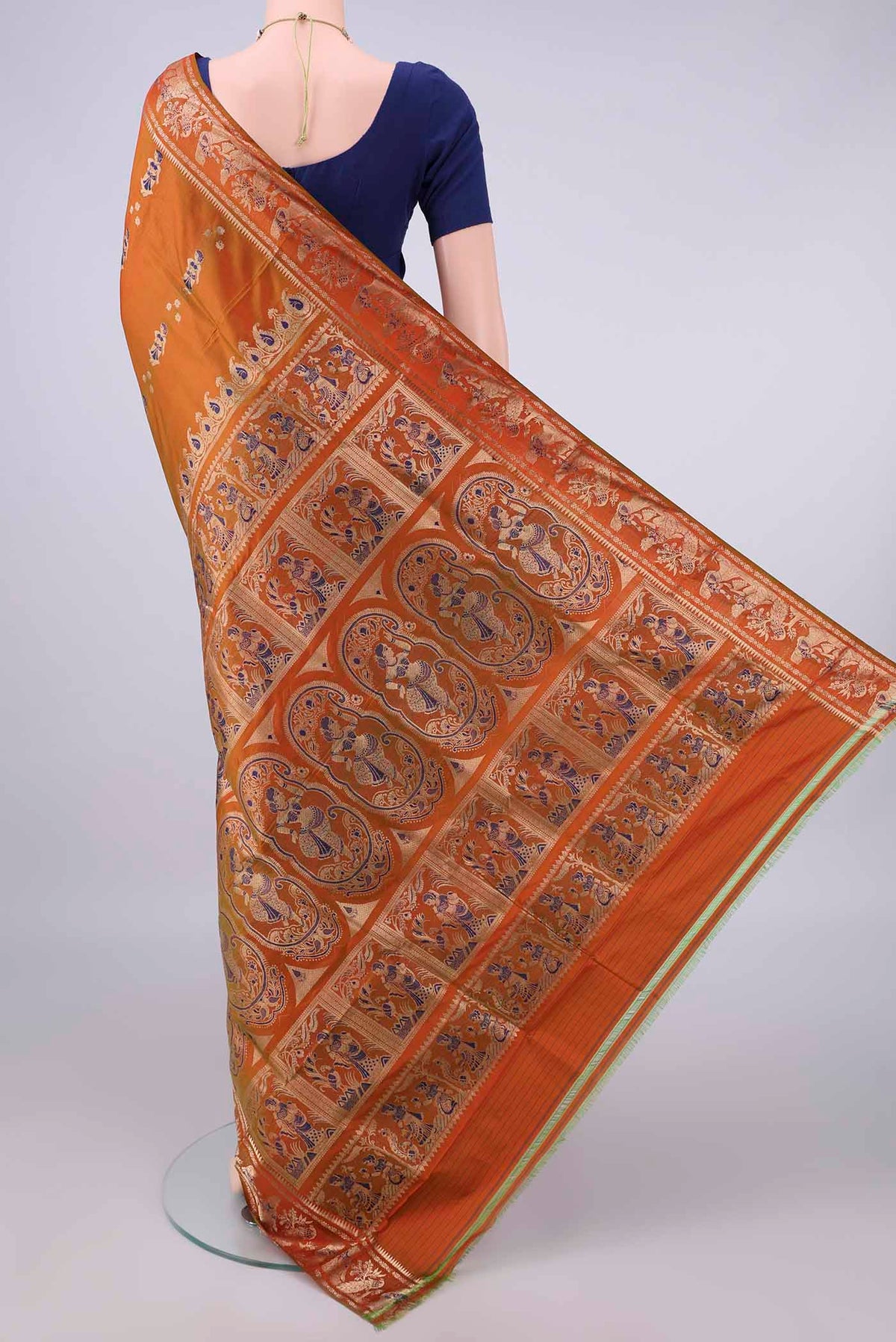 Flat view of Pure Silk Brick Orange Baluchari Saree with Zari And Thread Butta on the body and Zari Border. 