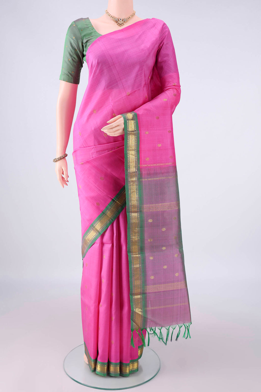 Pure Silk Pink Kanchipuram Saree with Zari Butta on the body and One Side Border.  displayed on a mannequin